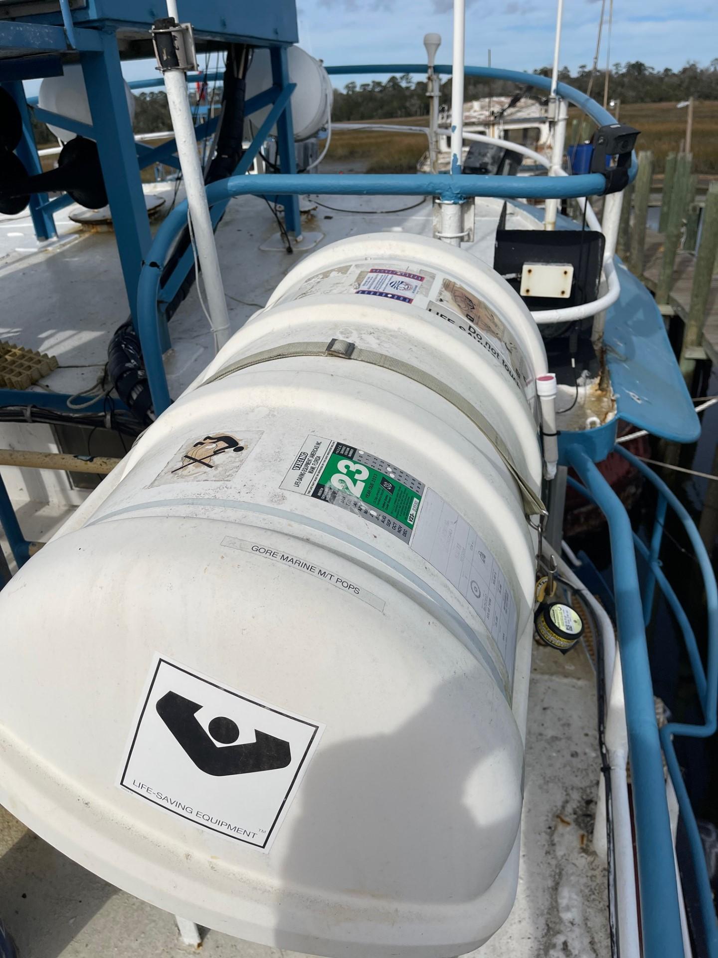 Commercial-Model Bow Tug 1961 -FL-US-1961 Commercial Model Bow Tug with safety equipment on deck, docked by the shore.-9787034 | Thumbnail