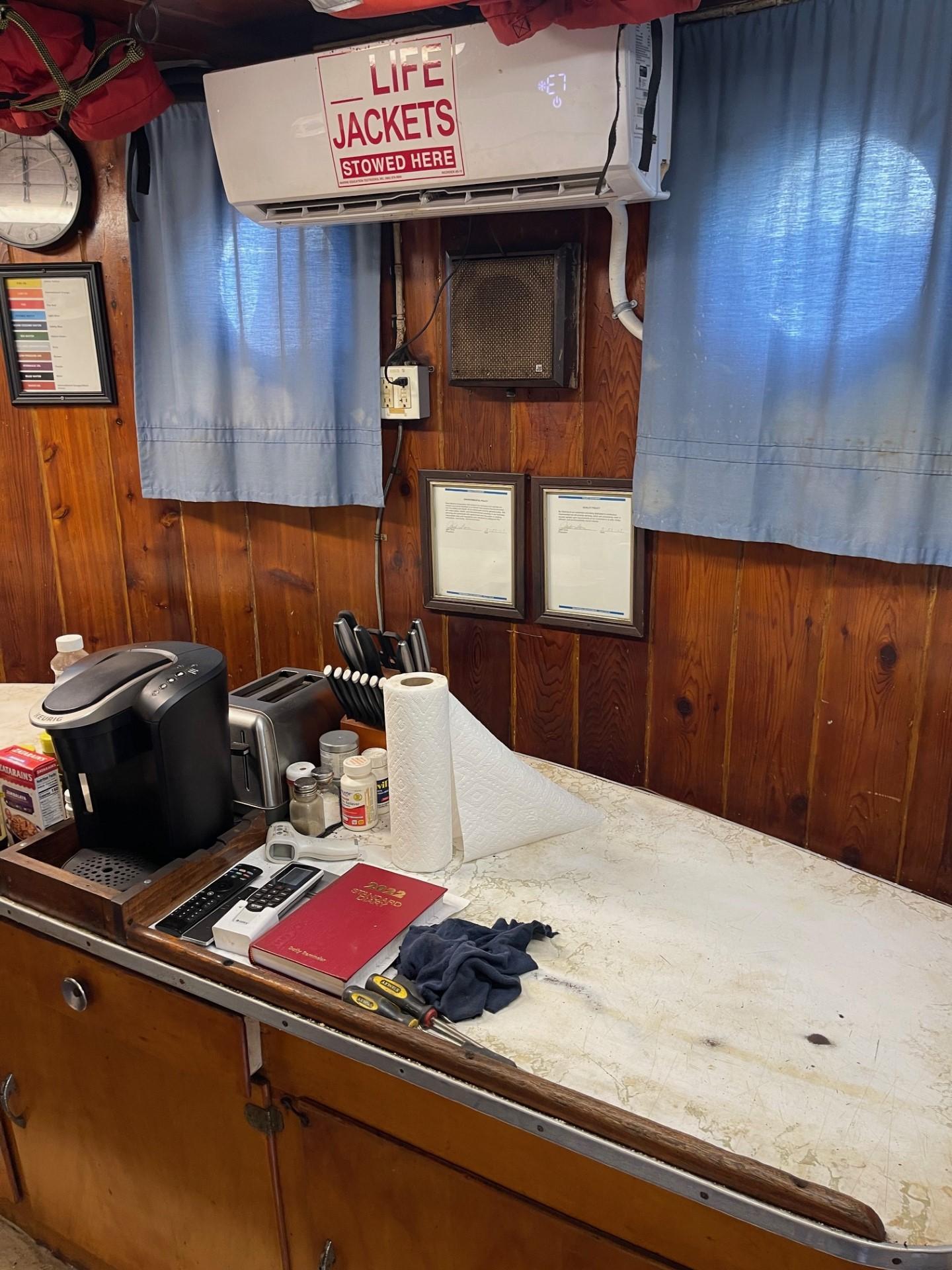 Commercial-Model Bow Tug 1961 -FL-US-Interior of a 1961 Model Bow Tug with kitchen counter and life jackets sign.-9787034 | Thumbnail