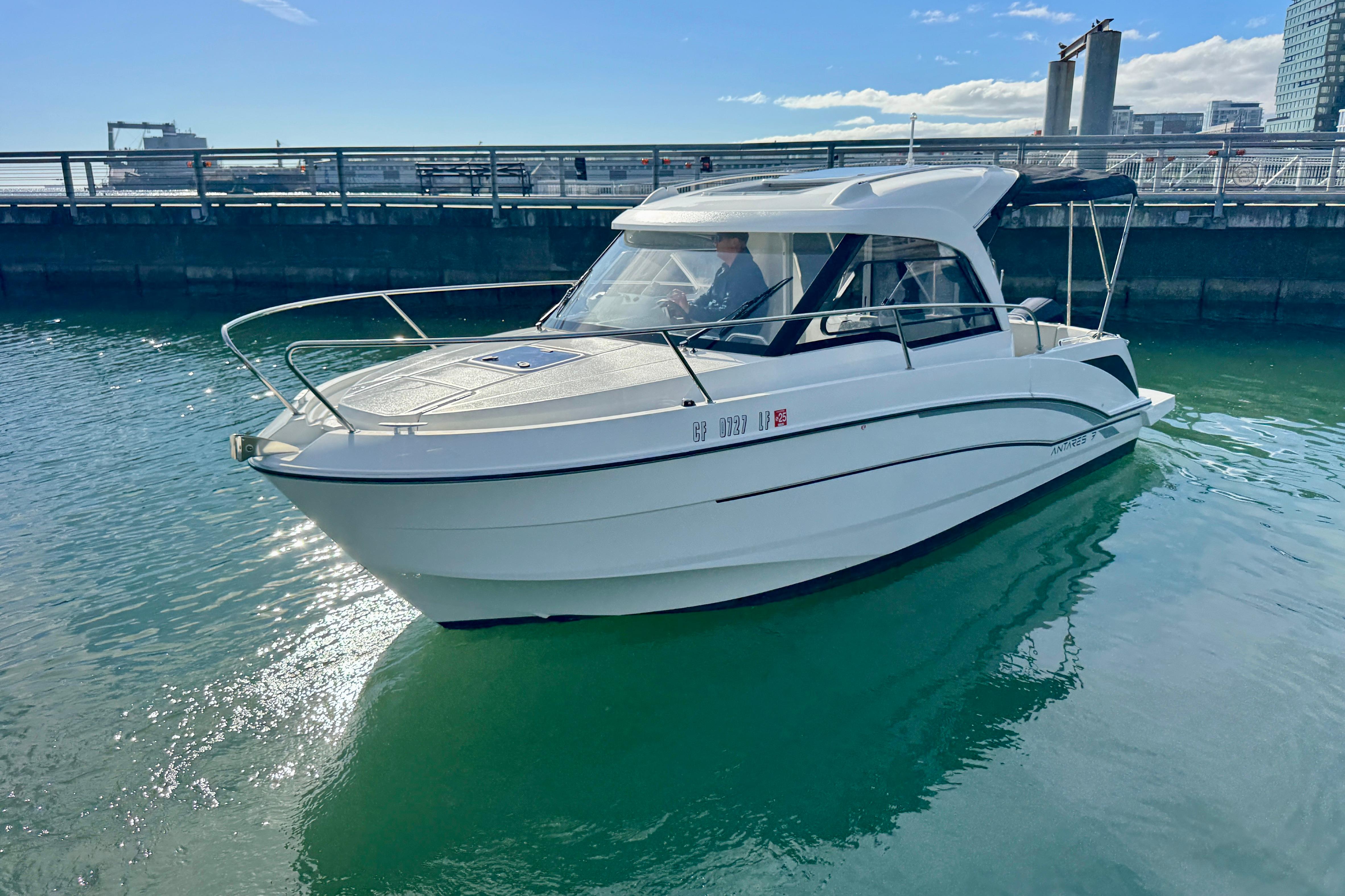 2022 Beneteau Antares 7 boat docked in a sunny marina setting.
