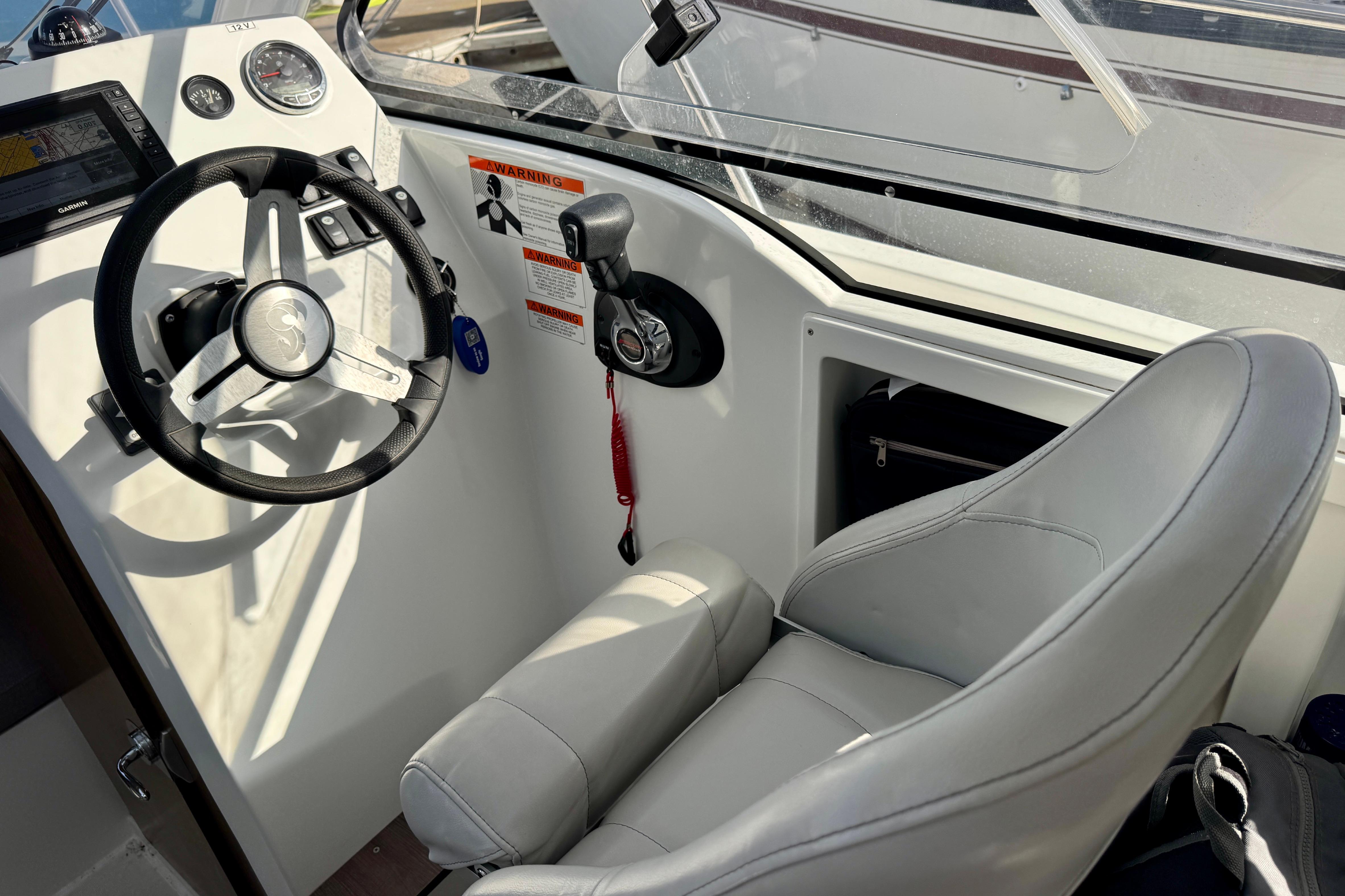 Interior cockpit of 2022 Beneteau Antares 7 with steering wheel and controls.