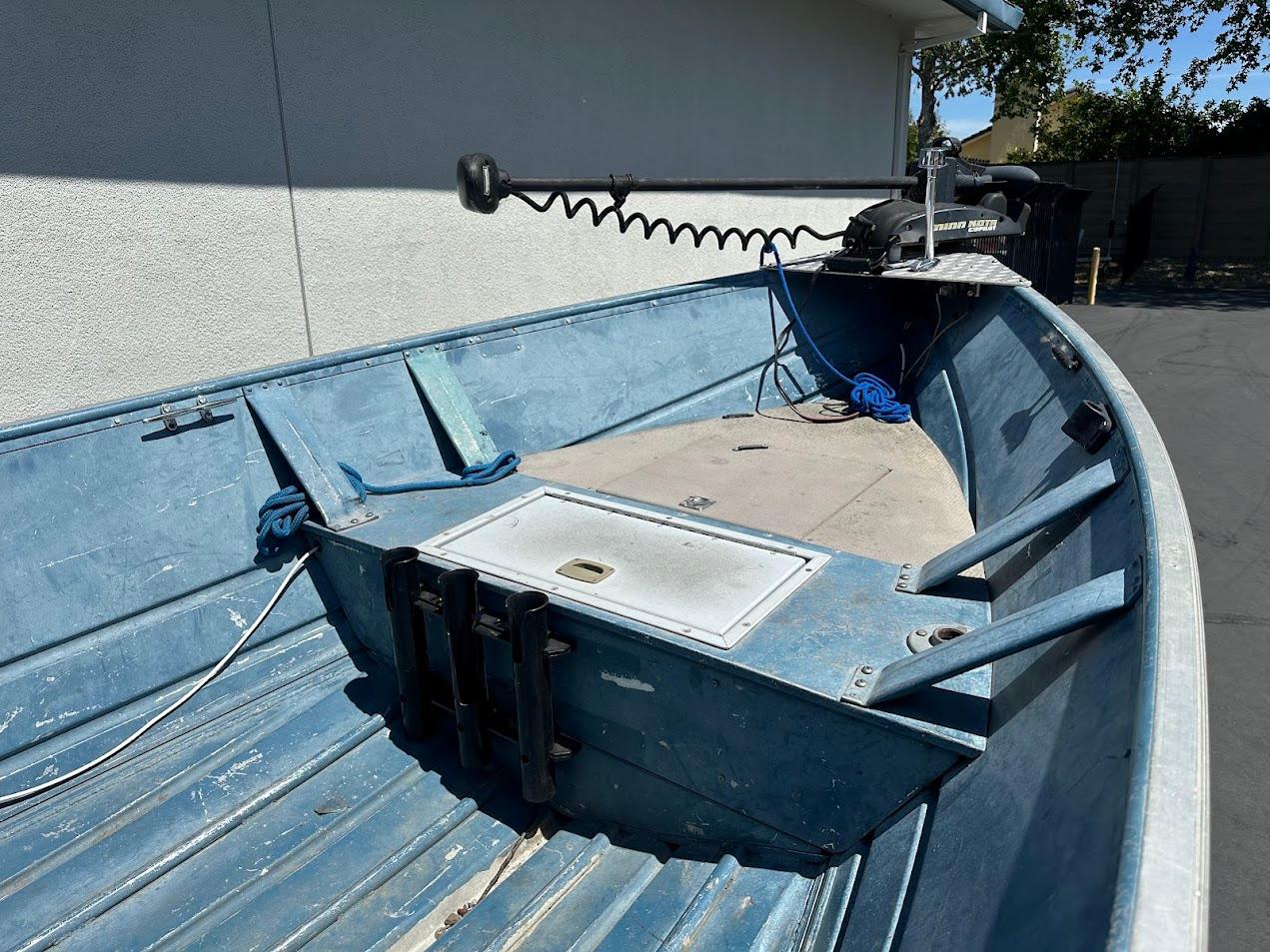 1998 Klamath 14 DLX boat with blue interior and trolling motor.