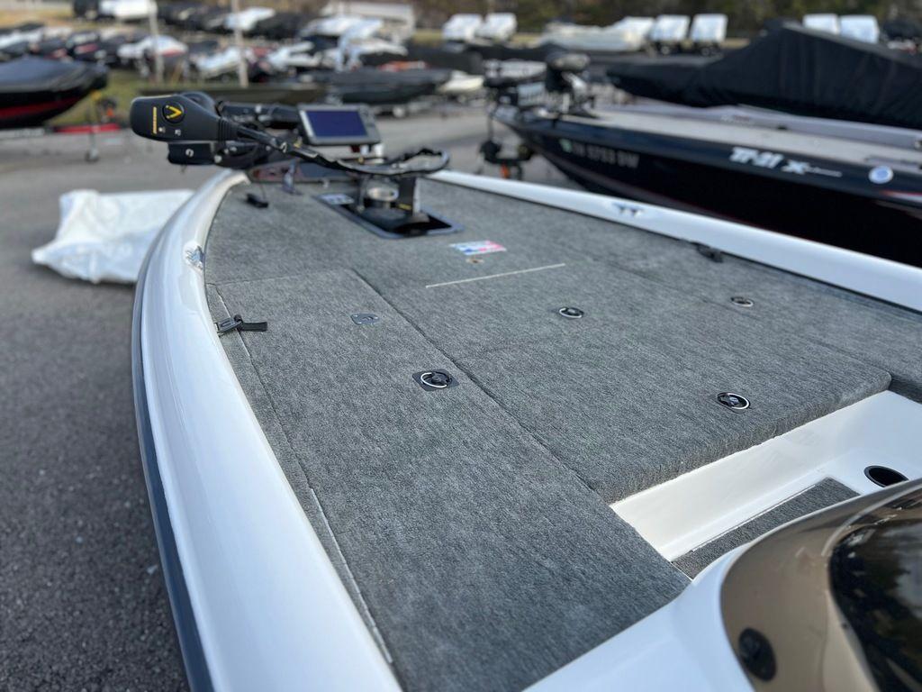 1999 Triton TR20 boat deck with mounted equipment in a marina setting.