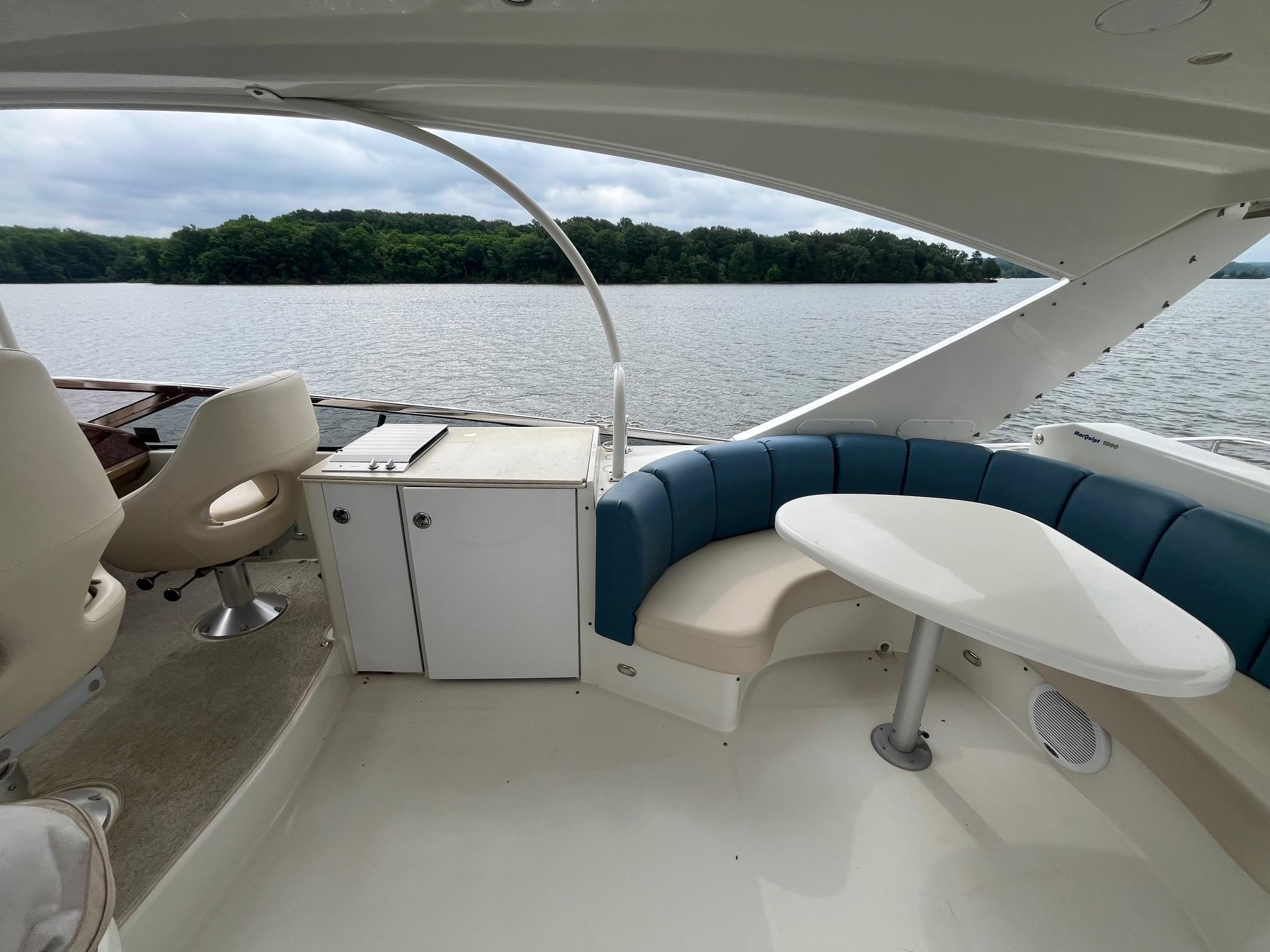 Marquis-59 2004 -IL-US-2004 Marquis 59 yacht interior with seating area and table, overlooking a serene lake.-9798156 | Thumbnail