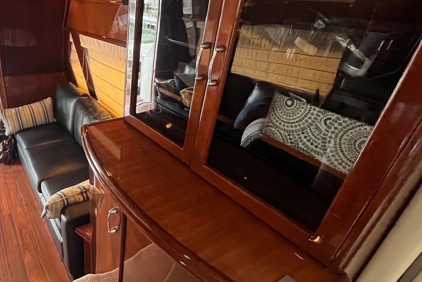 Marquis-59 2004 -IL-US-Luxurious interior of a 2004 Marquis 59 yacht with elegant wood cabinetry and plush seating.-9798156 | Thumbnail