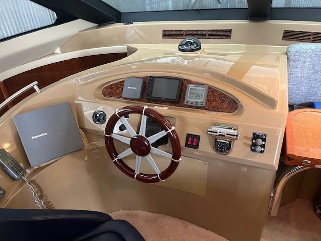 Marquis-59 2004 -IL-US-2004 Marquis 59 yacht helm with steering wheel, navigation instruments, and control panel.-9798156 | Thumbnail
