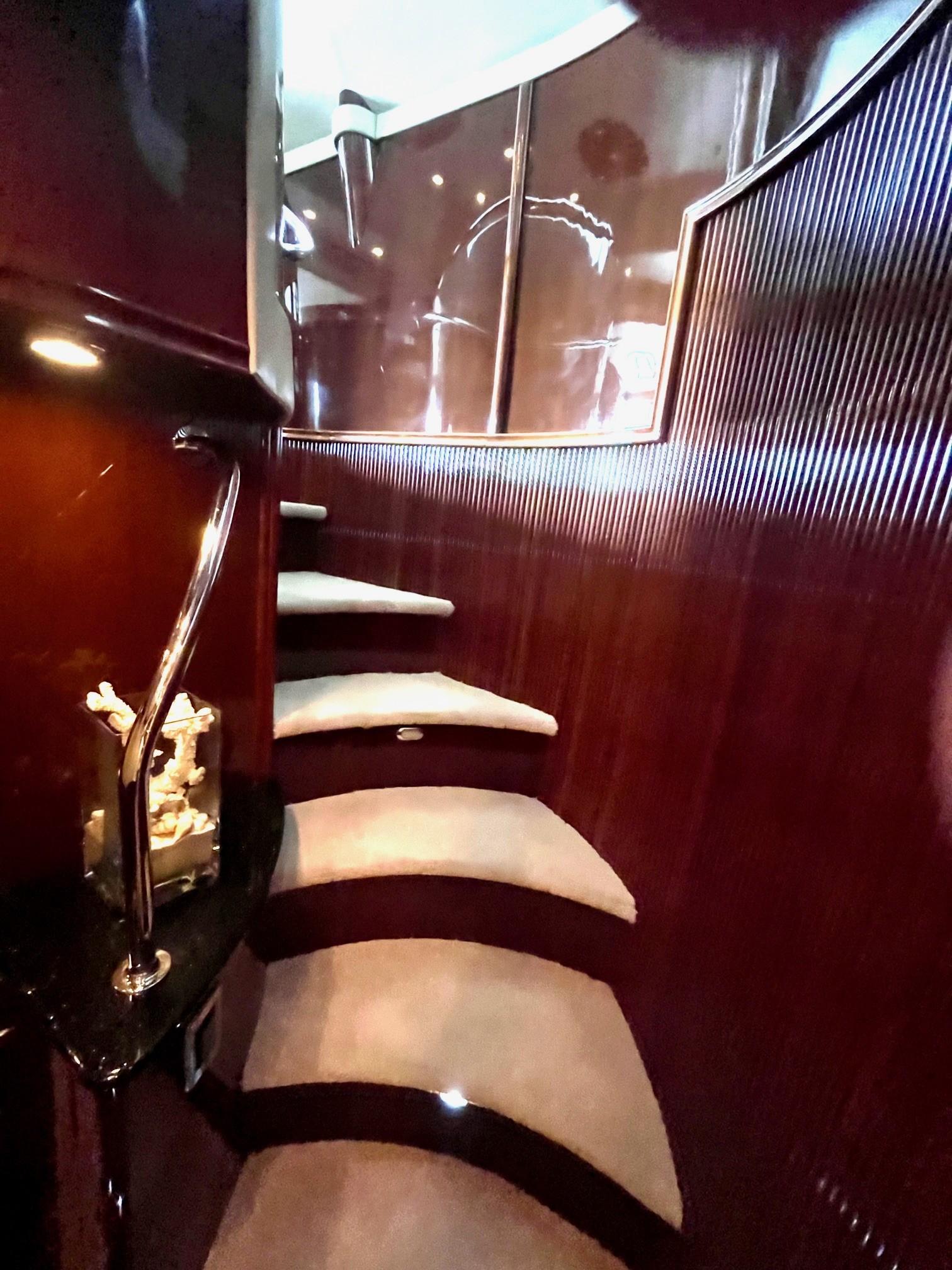 Marquis-59 2004 -IL-US-Luxurious interior staircase of a 2004 Marquis 59 yacht with elegant wood paneling.-9798156 | Thumbnail