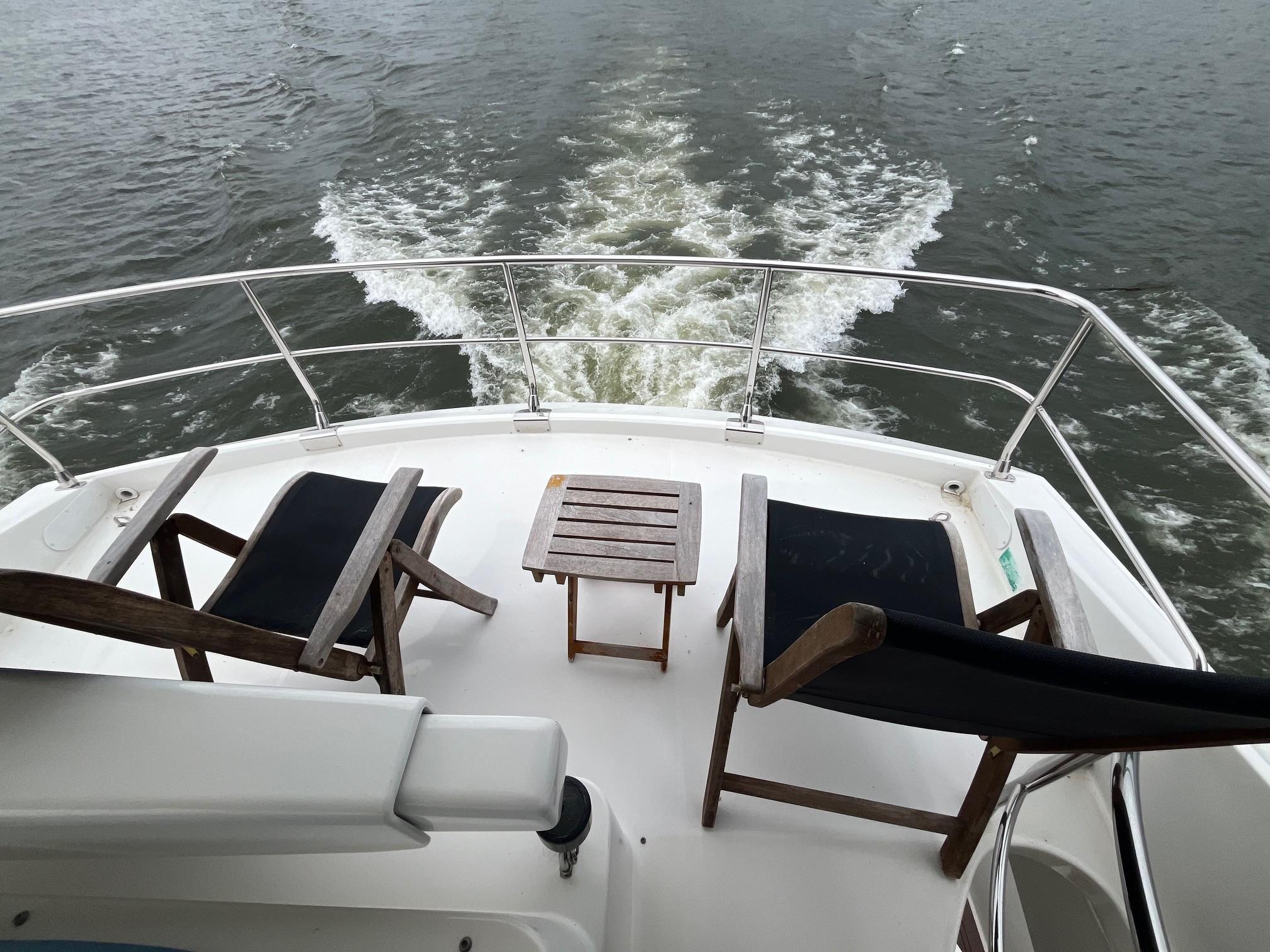 Marquis-59 2004 -IL-US-2004 Marquis 59 yacht deck with chairs and table overlooking water.-9798156 | Thumbnail