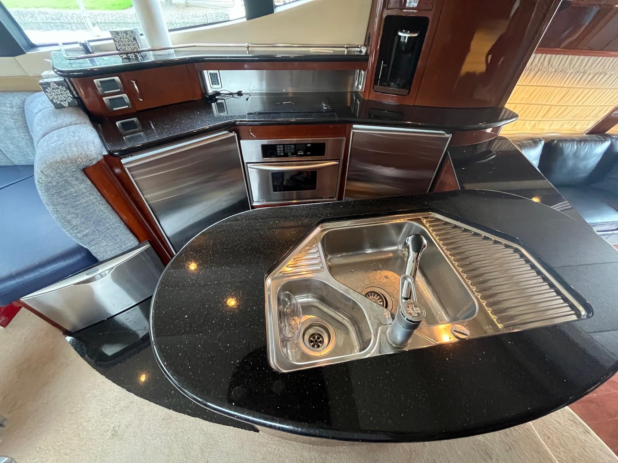 Marquis-59 2004 -IL-US-Luxurious kitchen area in a 2004 Marquis 59 yacht with modern appliances and sleek design.-9798156 | Thumbnail