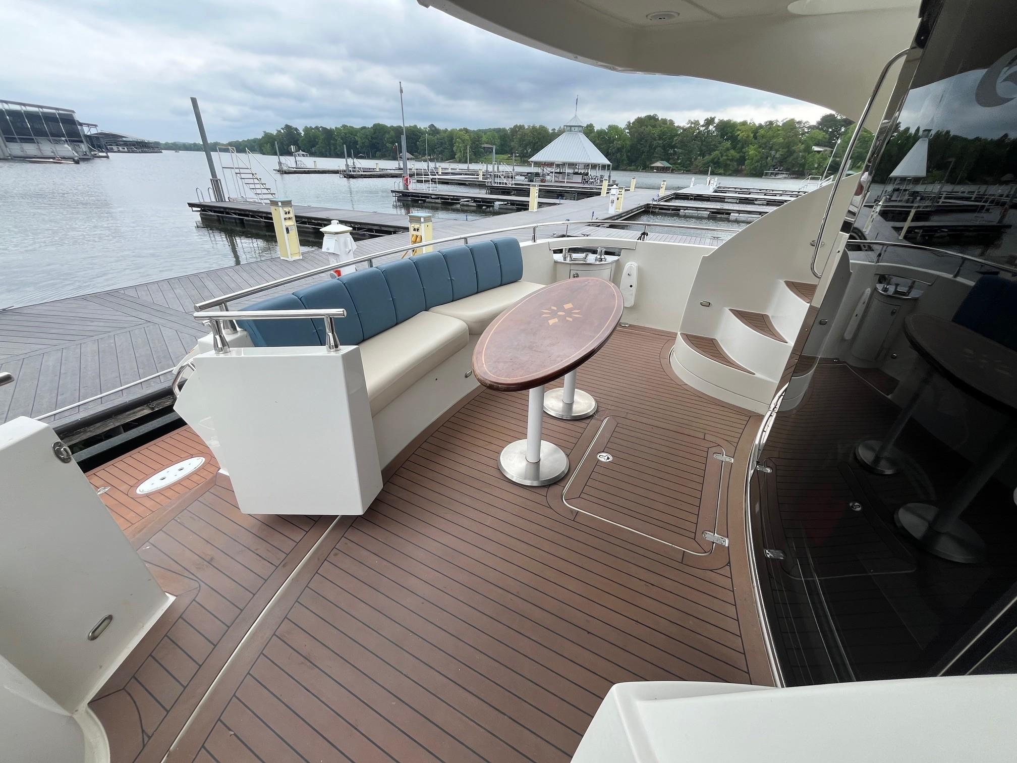 Marquis-59 2004 -IL-US-2004 Marquis 59 yacht deck with seating, table, and marina view.-9798156 | Thumbnail