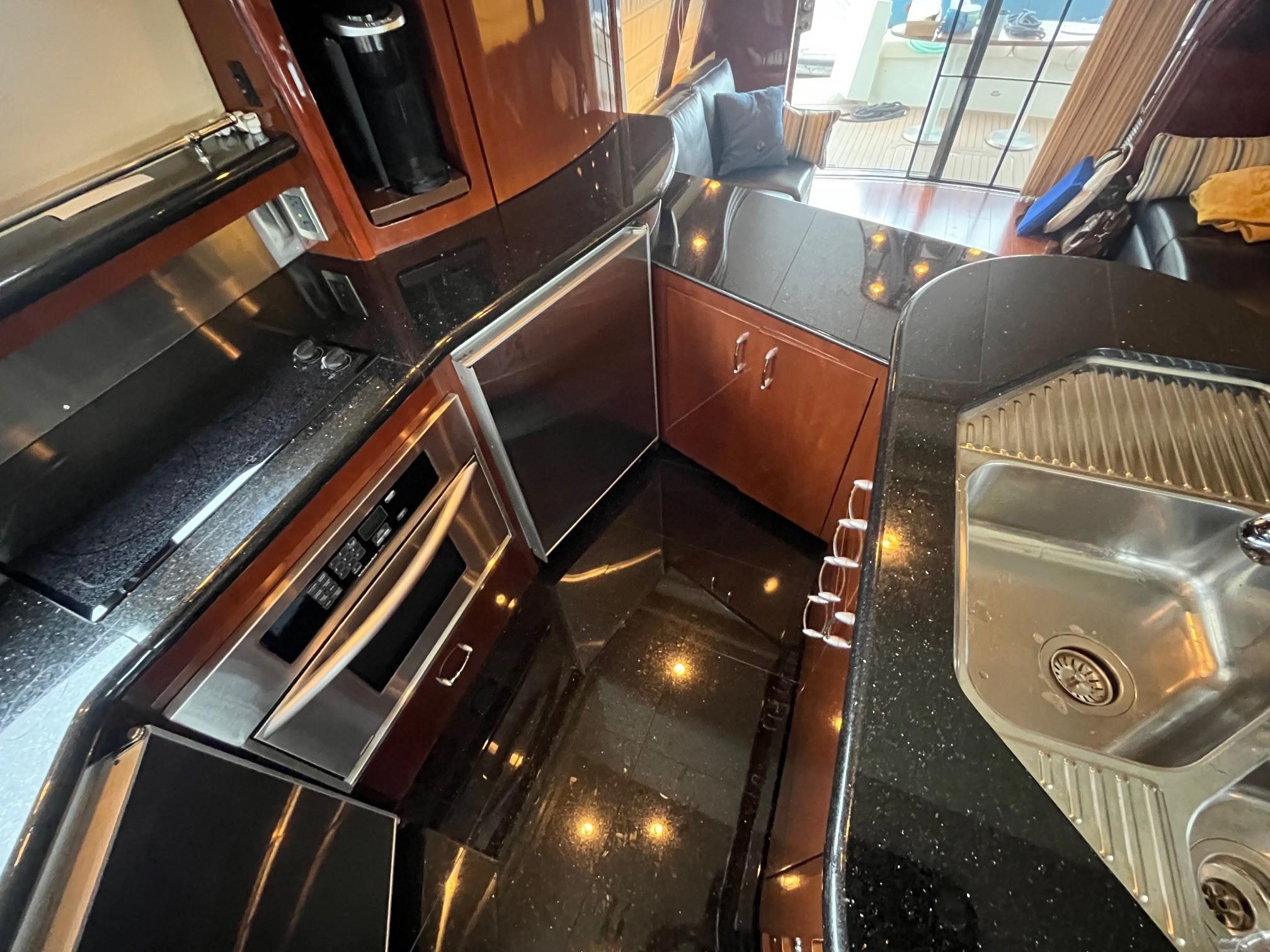 Marquis-59 2004 -IL-US-Luxurious kitchen interior of a 2004 Marquis 59 yacht with sleek countertops and modern appliances.-9798156 | Thumbnail