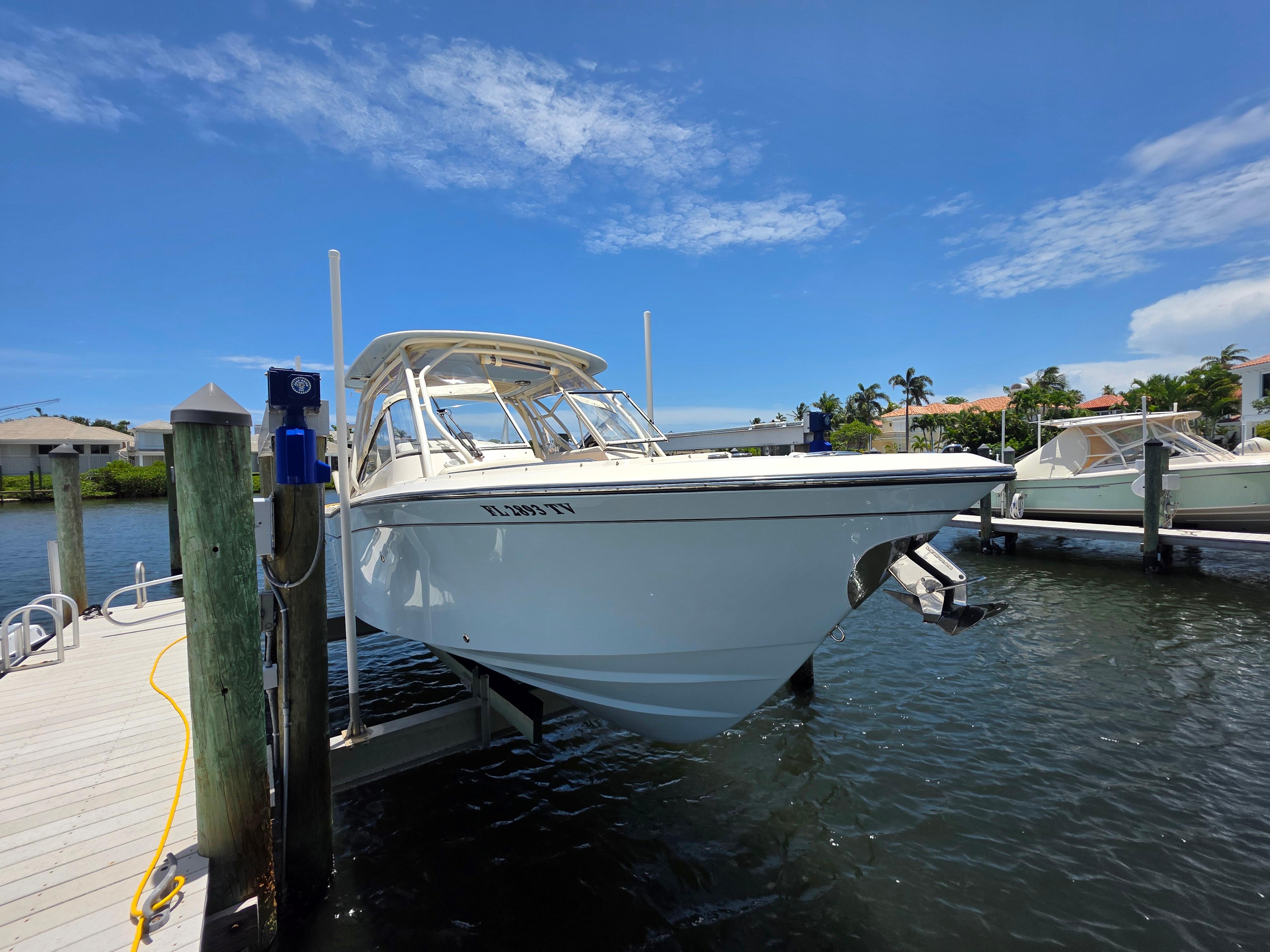2023 Grady-White Freedom 275 boat docked on a sunny day.