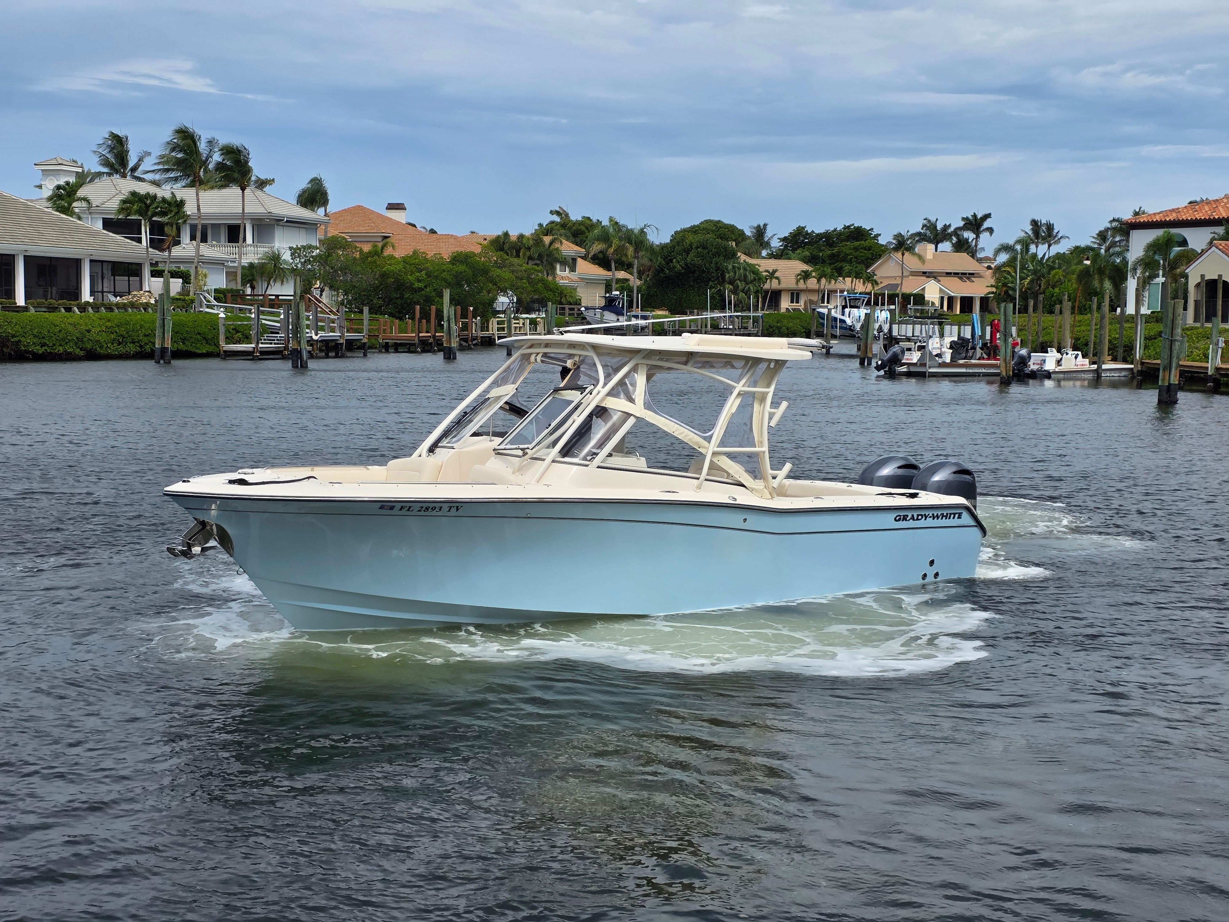 2023 Grady-White Freedom 275 boat cruising in a scenic waterfront setting.