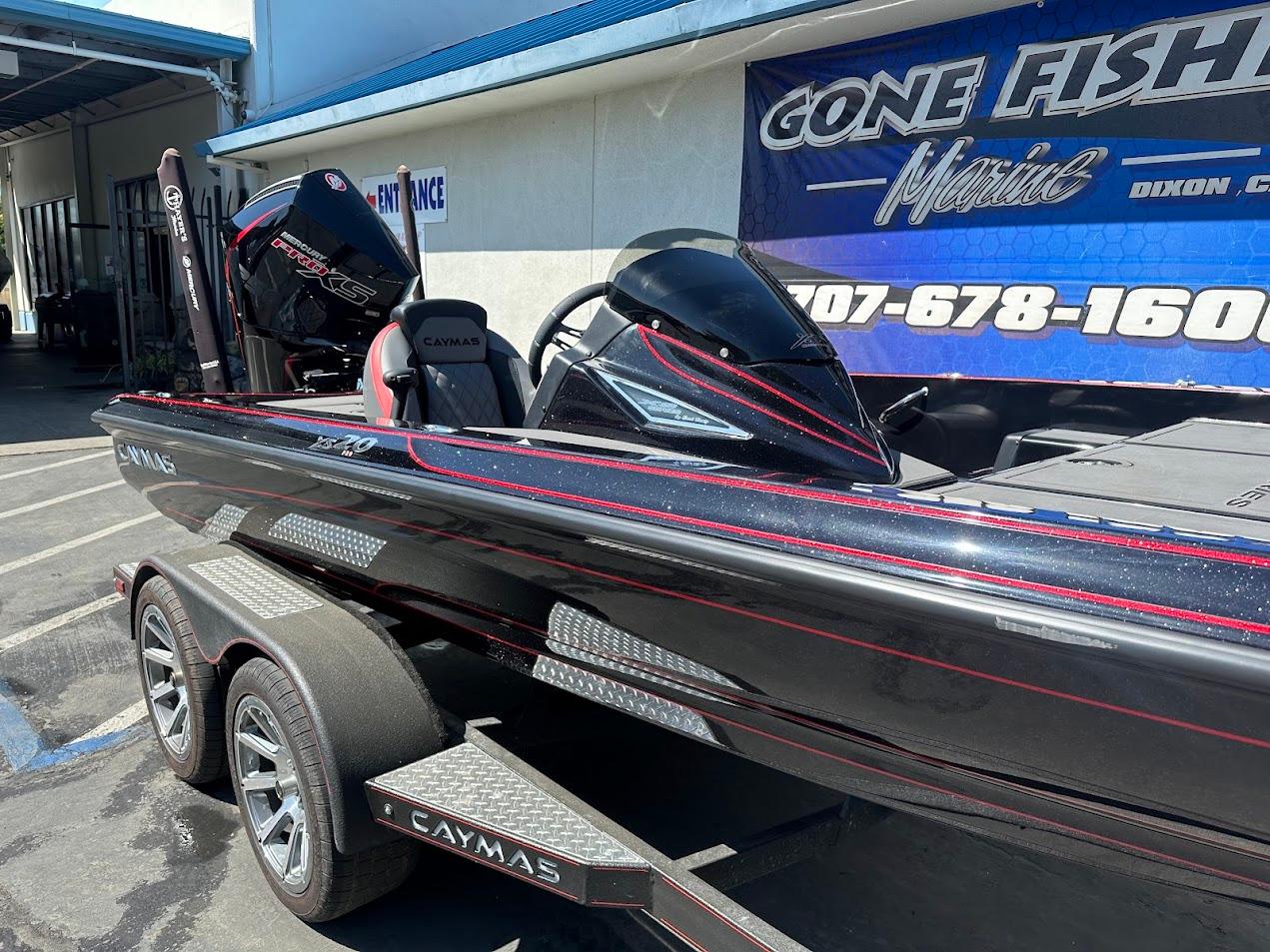 2024 Caymas XS 20 Pro boat with sleek black and red design at dealership.