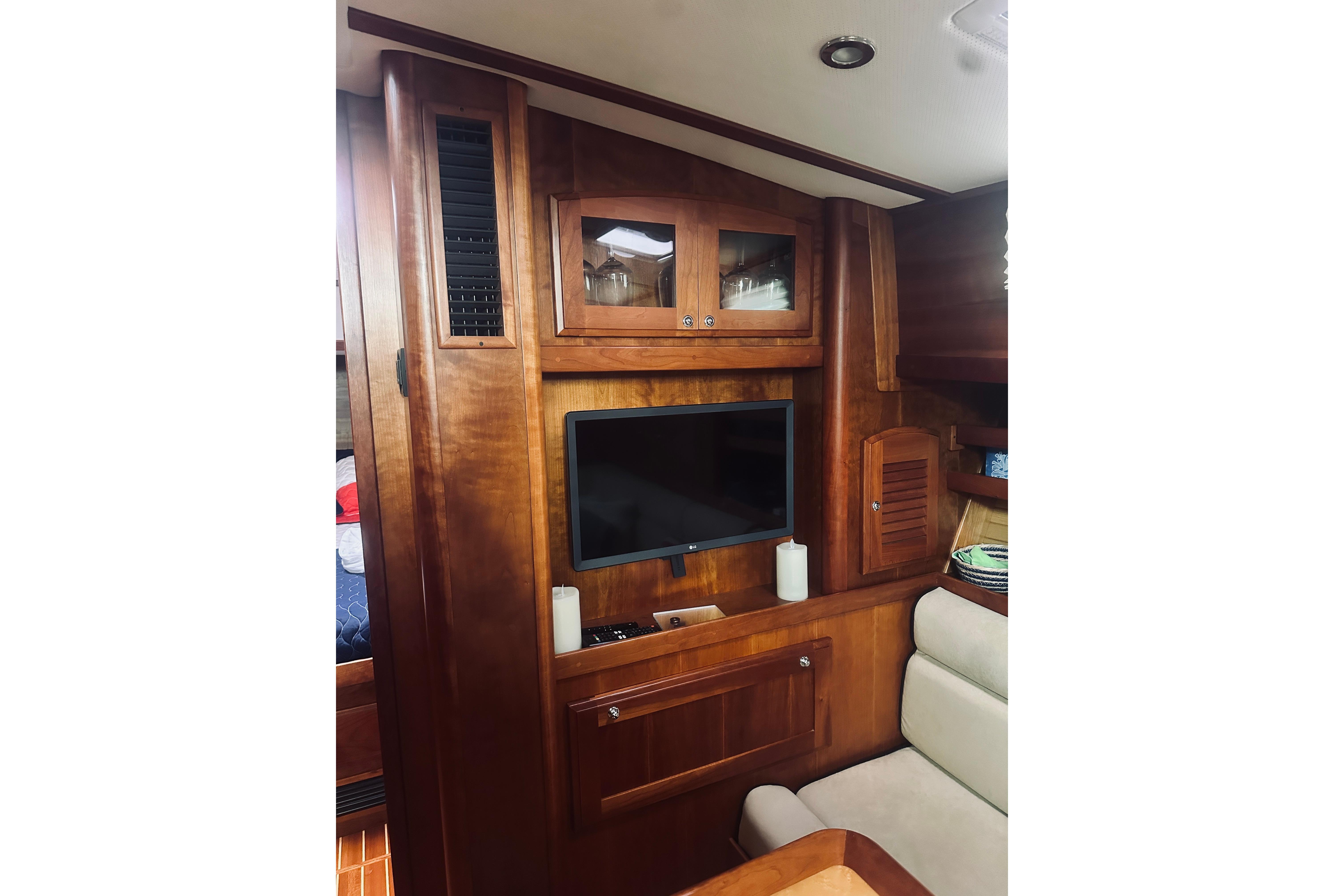 Interior of 2008 Sabre 38 Hard Top Express with wood cabinetry and mounted TV.