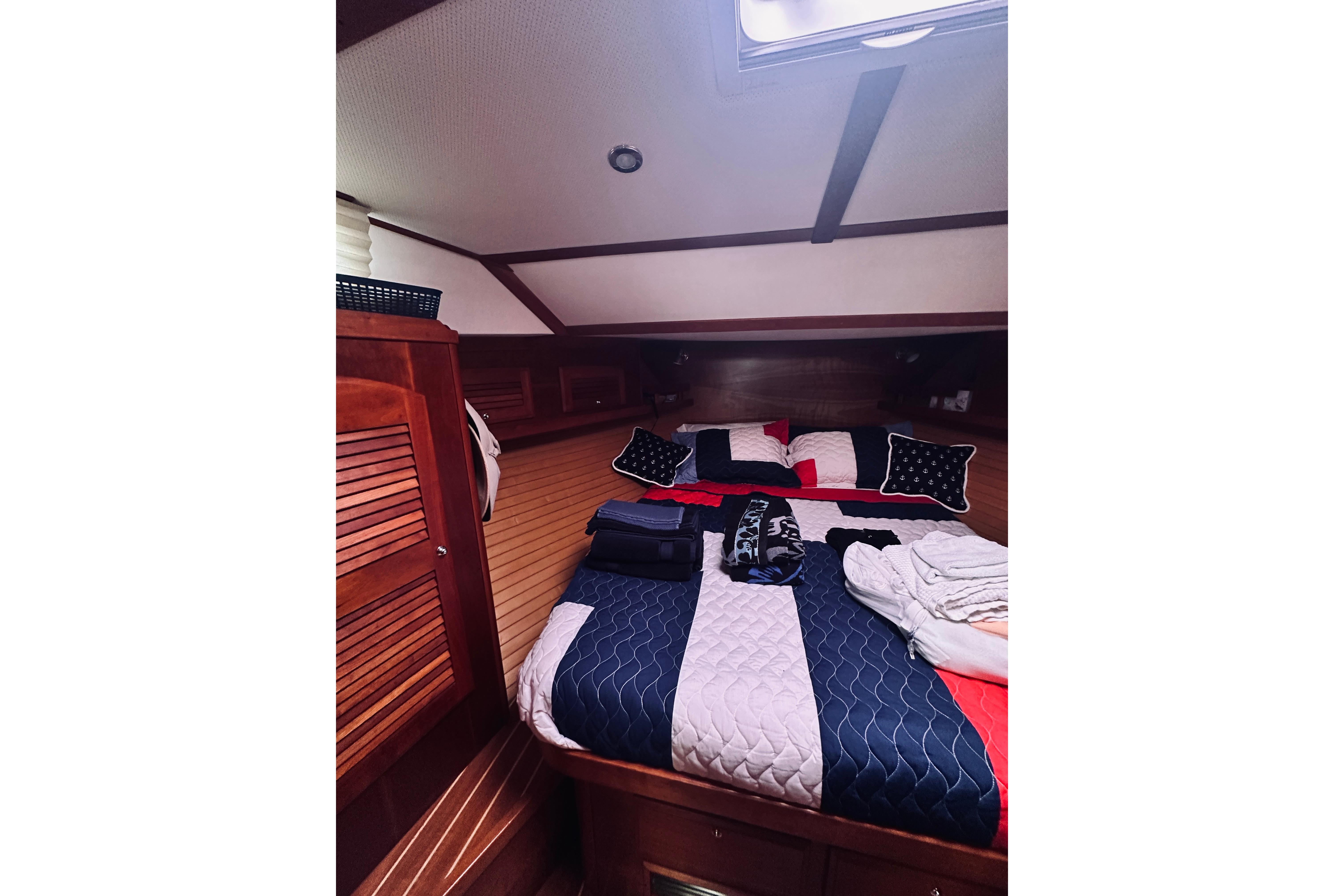 Cozy cabin interior of 2008 Sabre 38 Hard Top Express with nautical bedding.