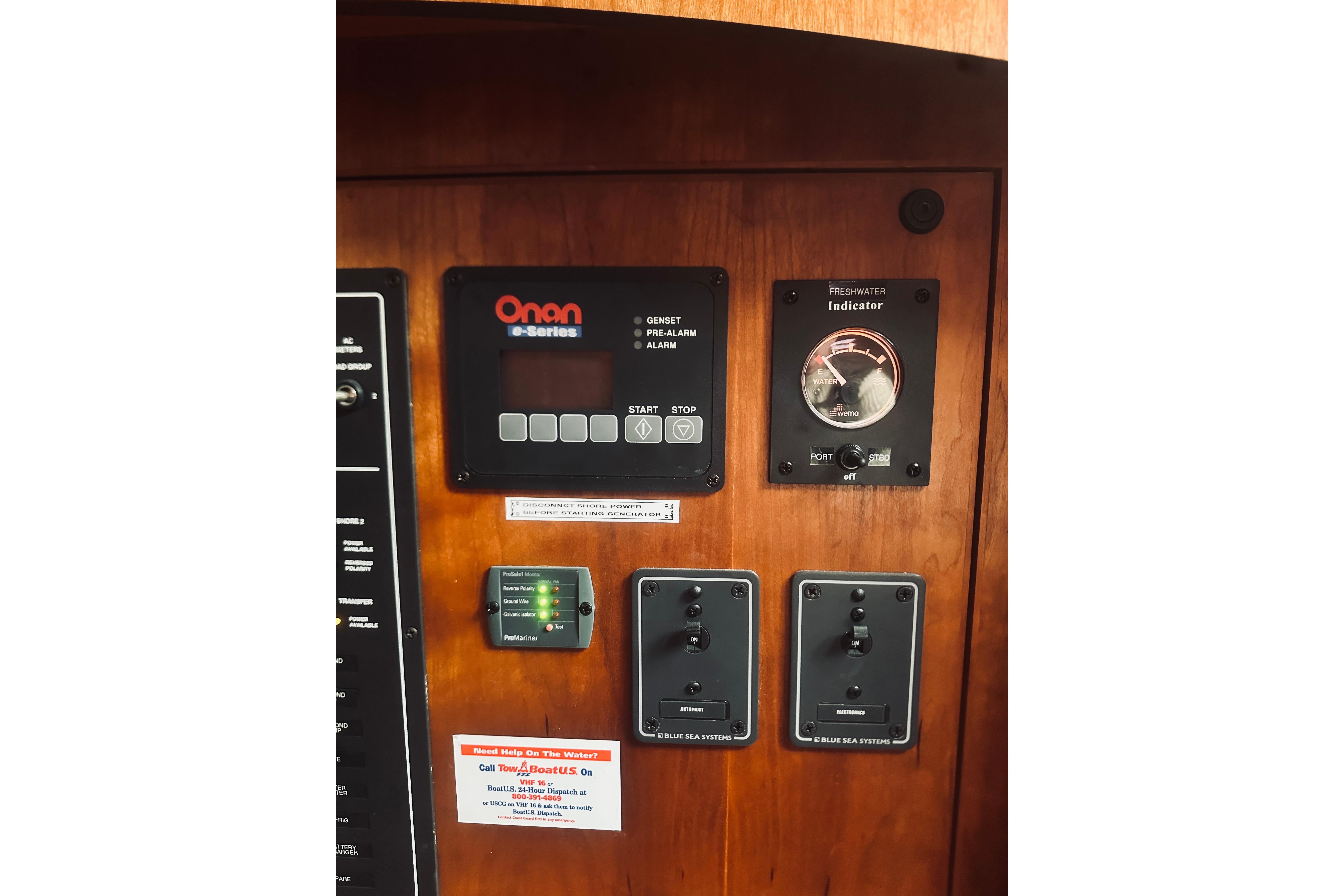 Control panel of a 2008 Sabre 38 Hard Top Express boat, featuring Onan e-Series.