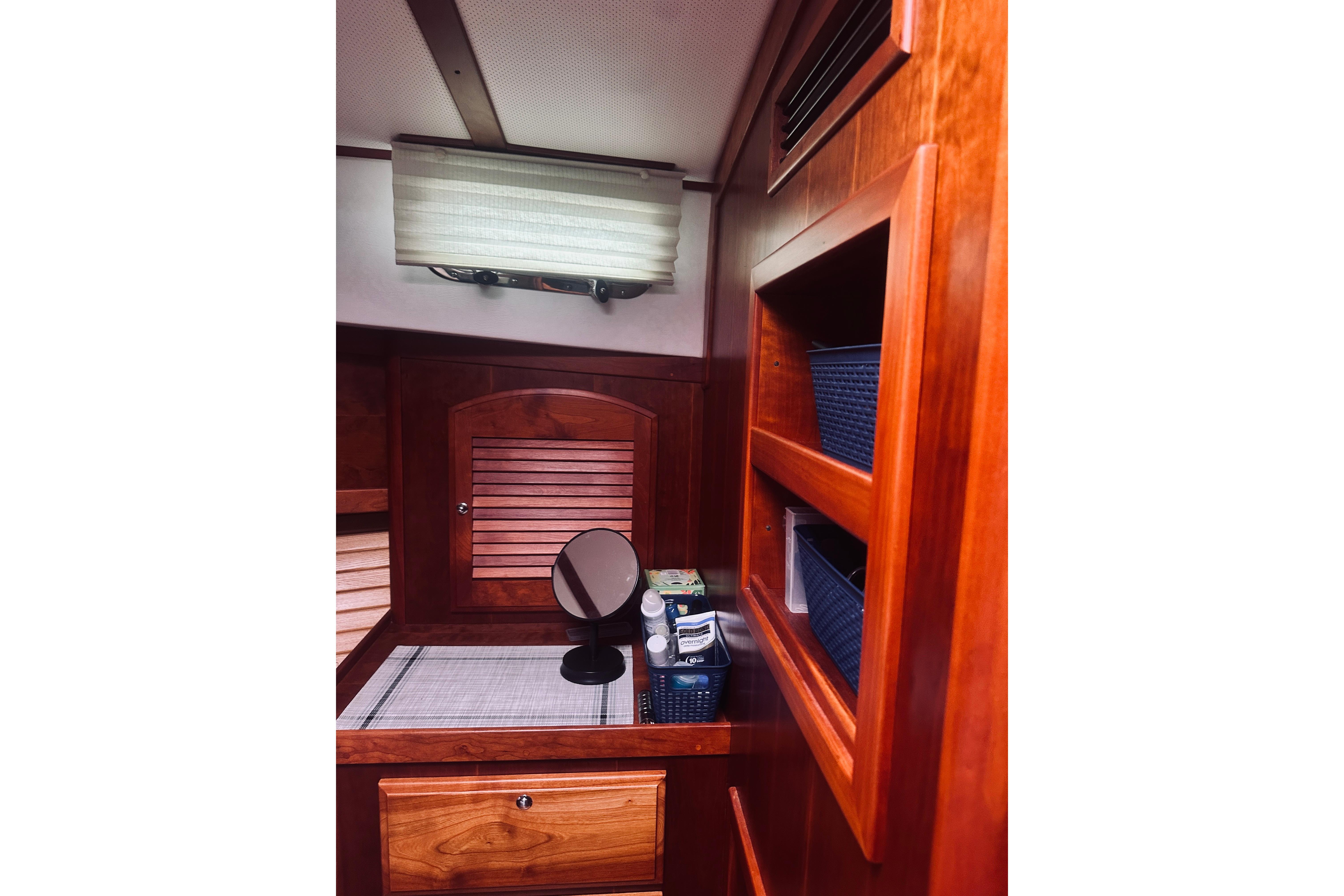 Interior of 2008 Sabre 38 Hard Top Express with wooden cabinetry and storage shelves.