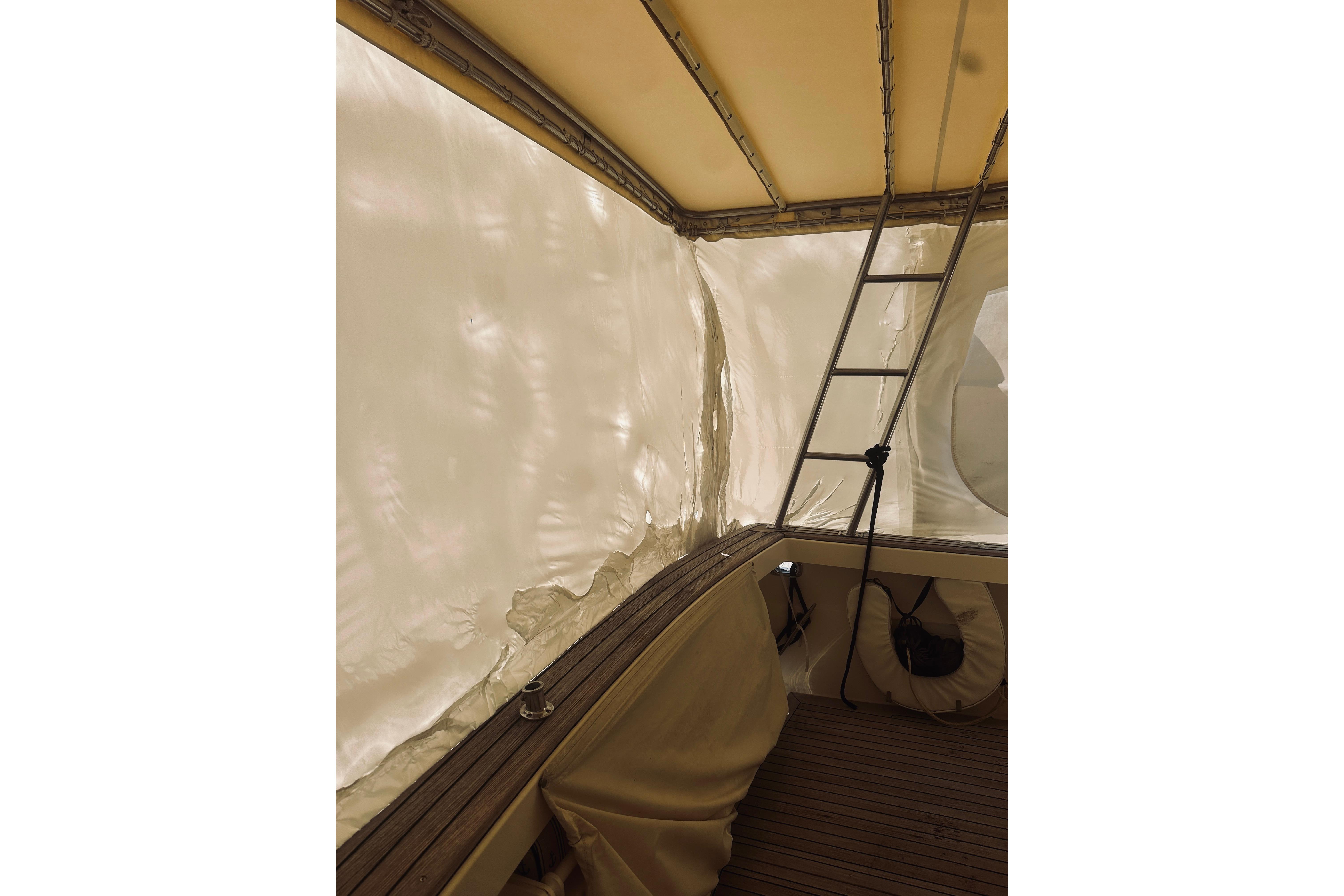 2008 Sabre 38 Hard Top Express interior with ladder and covered seating area.