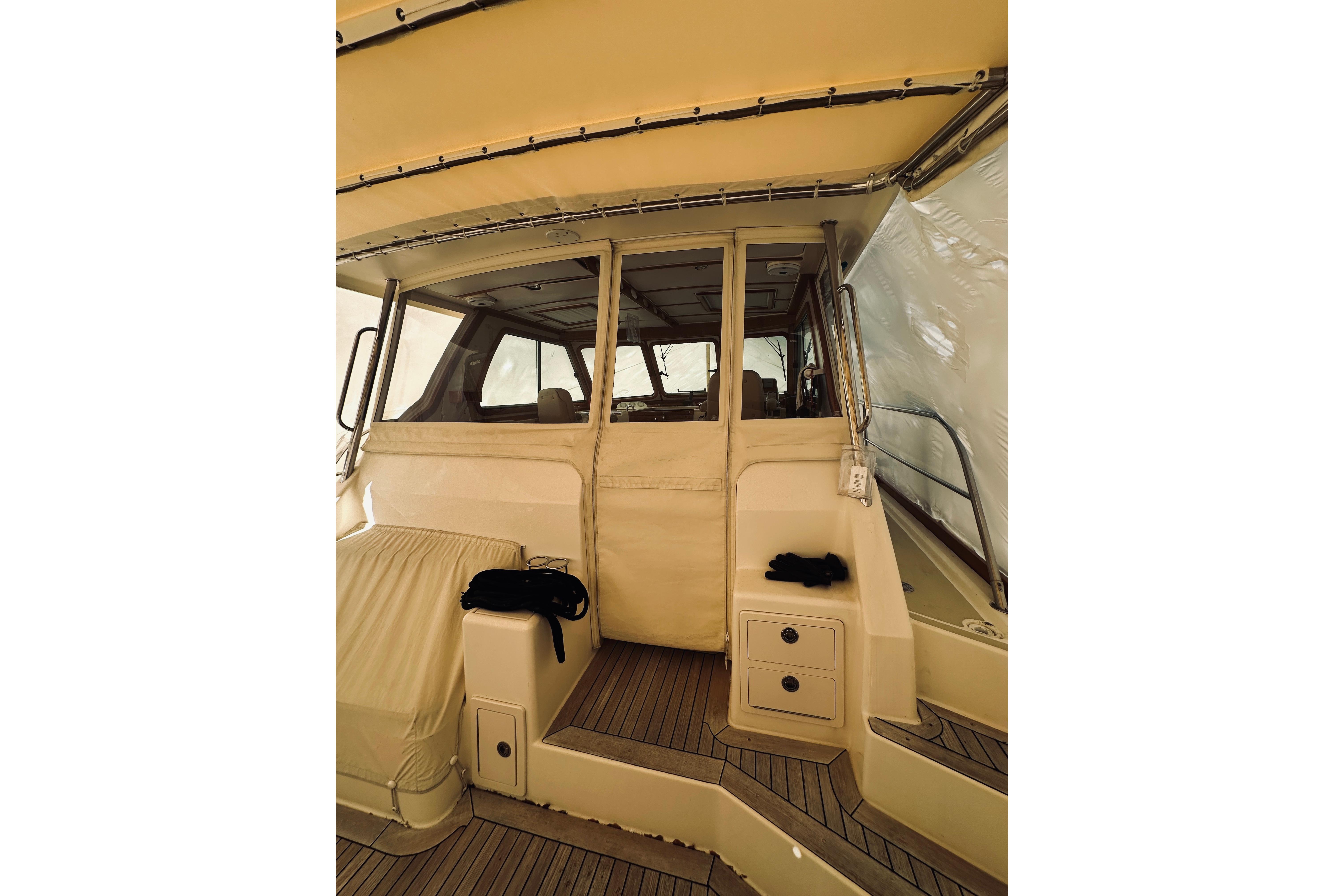 2008 Sabre 38 Hard Top Express boat interior with beige seating and wooden flooring.