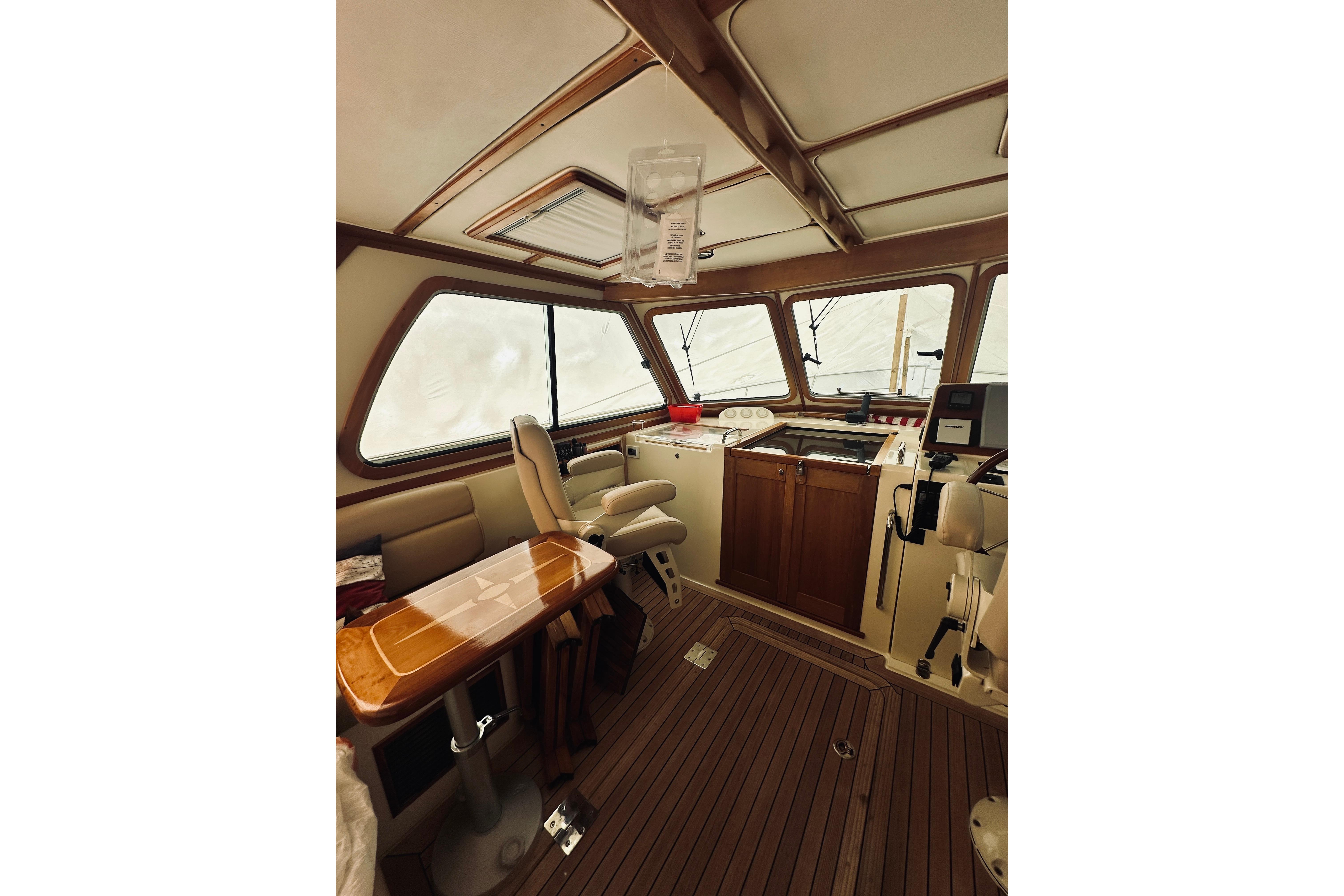 2008 Sabre 38 Hard Top Express interior with wood accents and helm station.