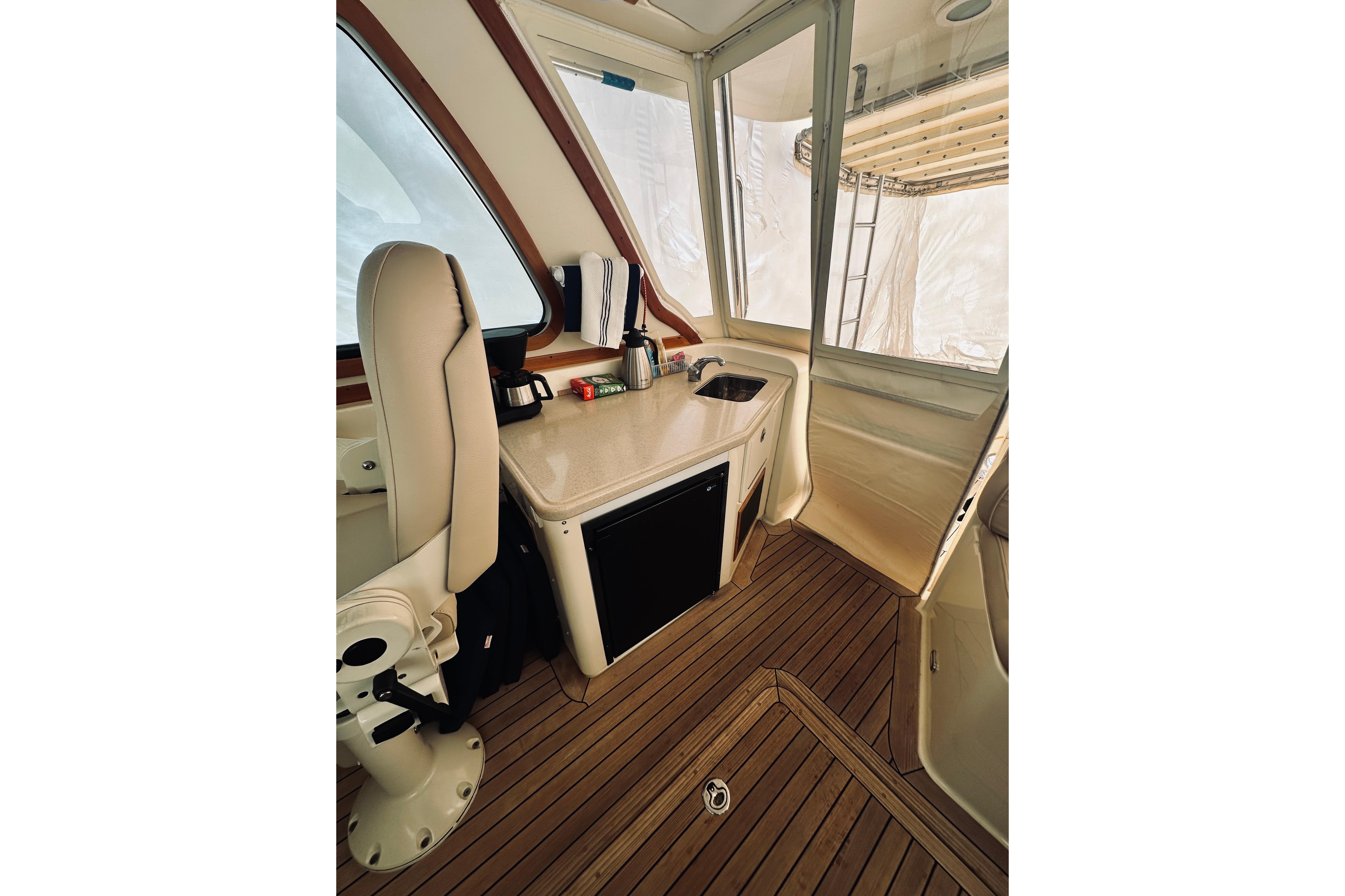 2008 Sabre 38 Hard Top Express interior with helm seat and kitchenette.