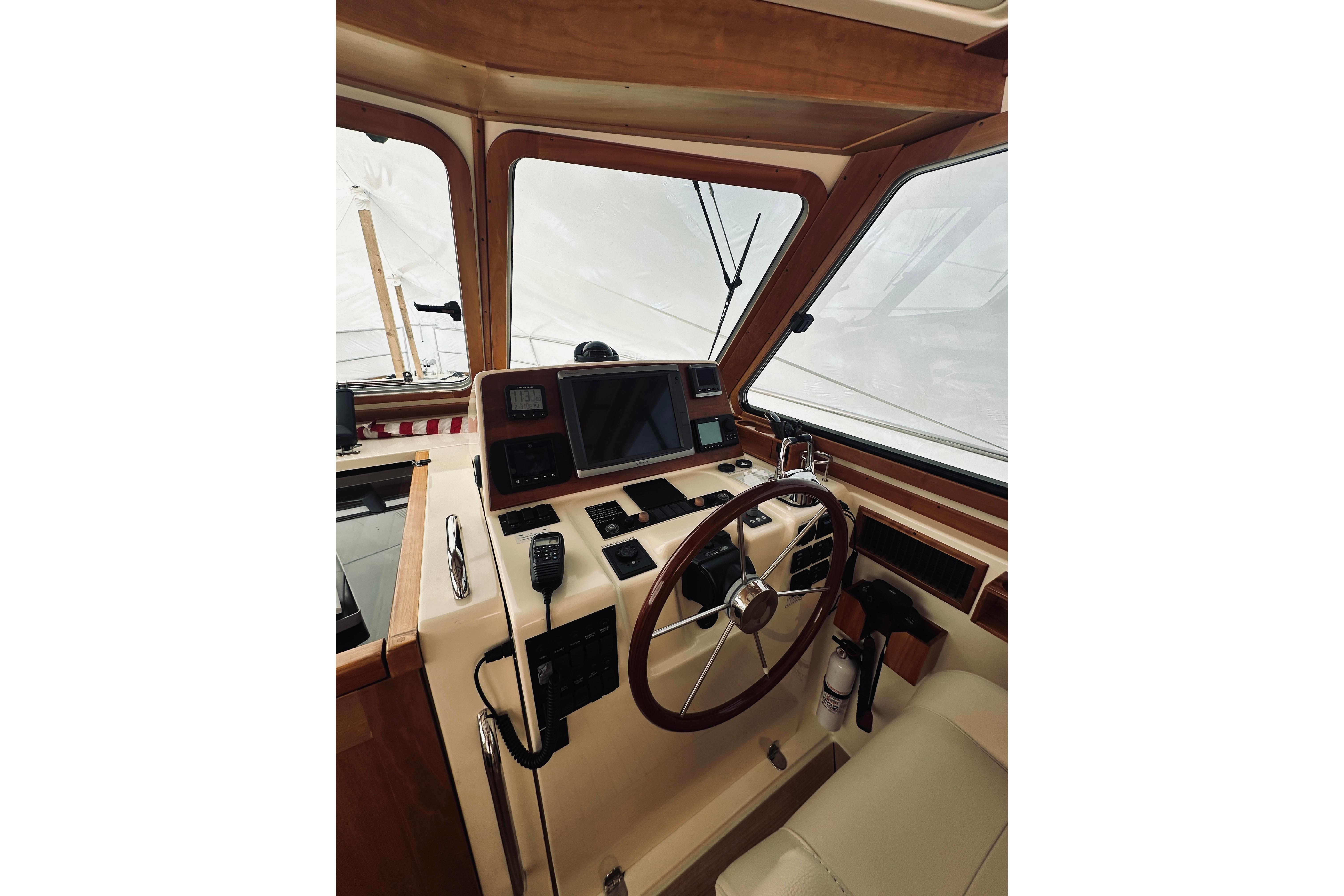 2008 Sabre 38 Hard Top Express helm with steering wheel and navigation equipment.