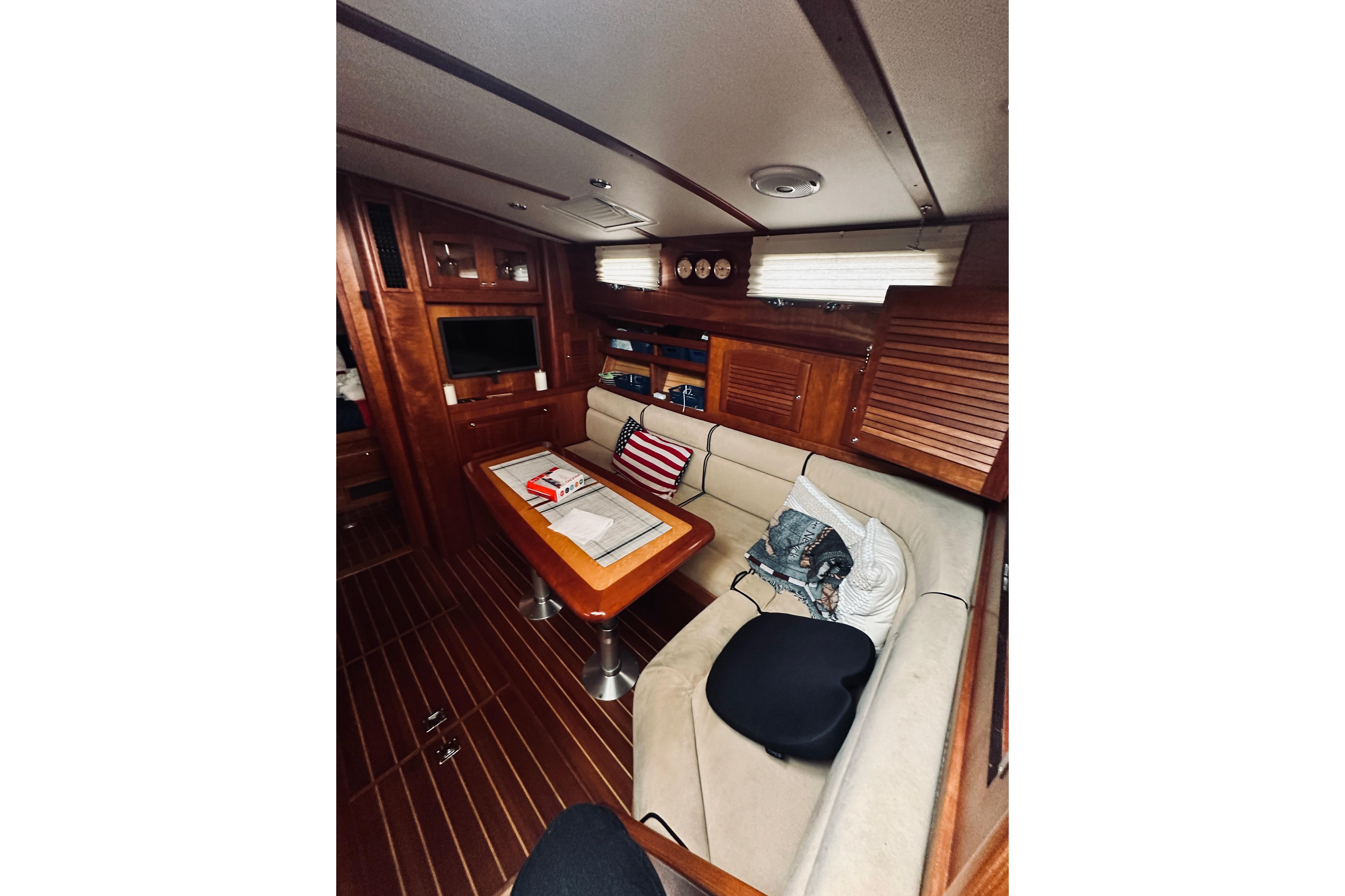 Interior of 2008 Sabre 38 Hard Top Express yacht with cozy seating and wooden finishes.