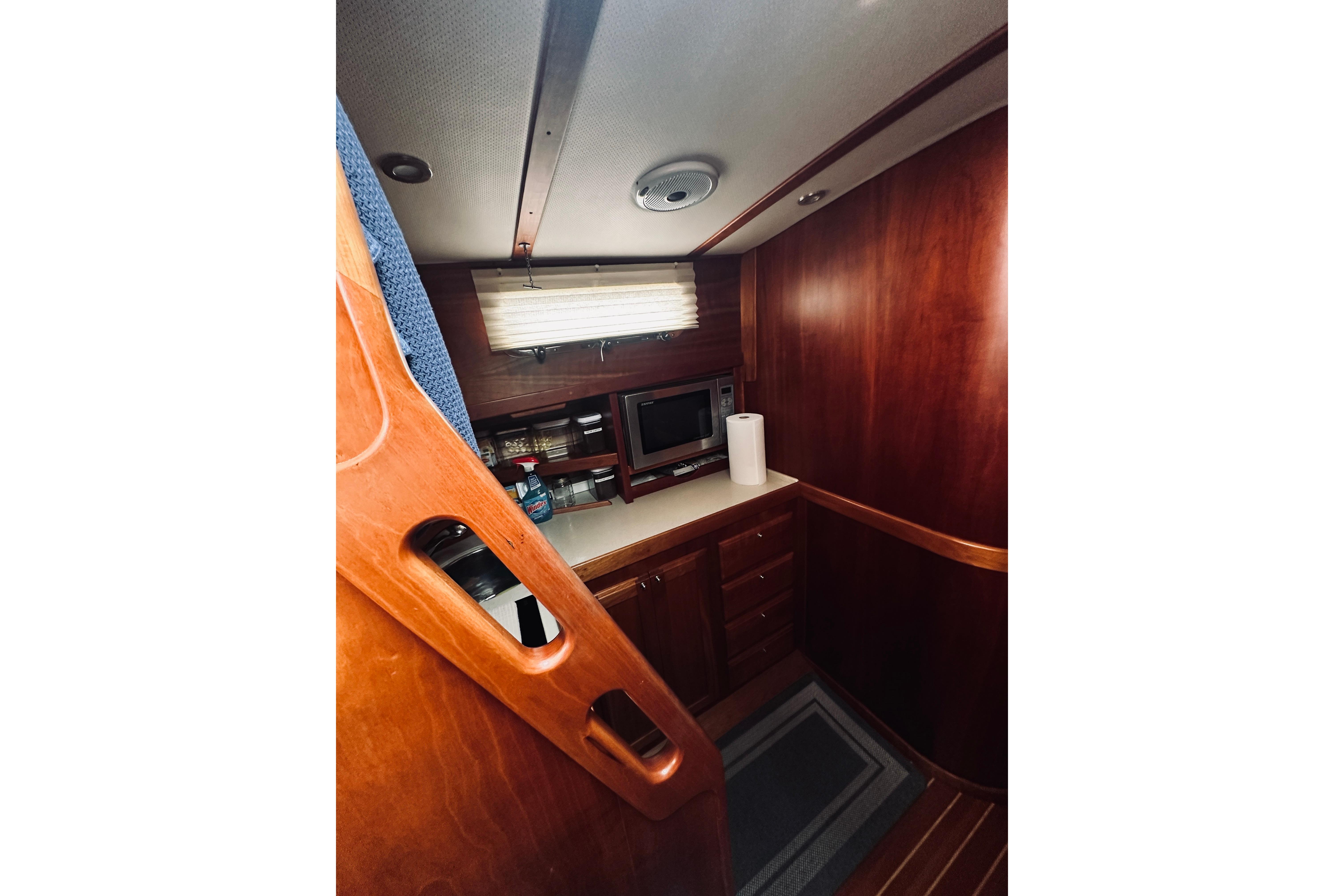 Interior of 2008 Sabre 38 Hard Top Express yacht with wooden cabinetry and modern amenities.