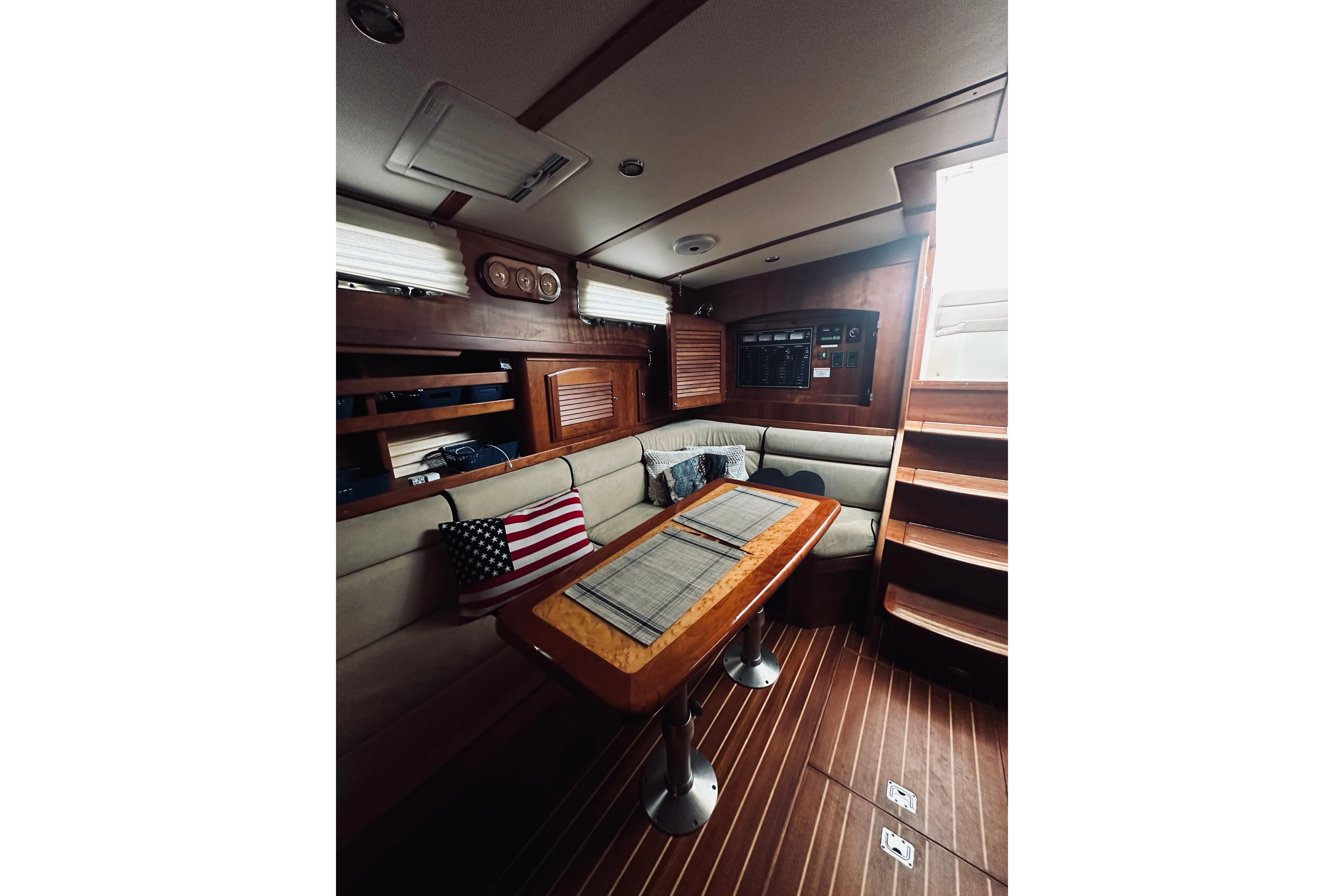 Interior of 2008 Sabre 38 Hard Top Express with cozy seating and wooden accents.