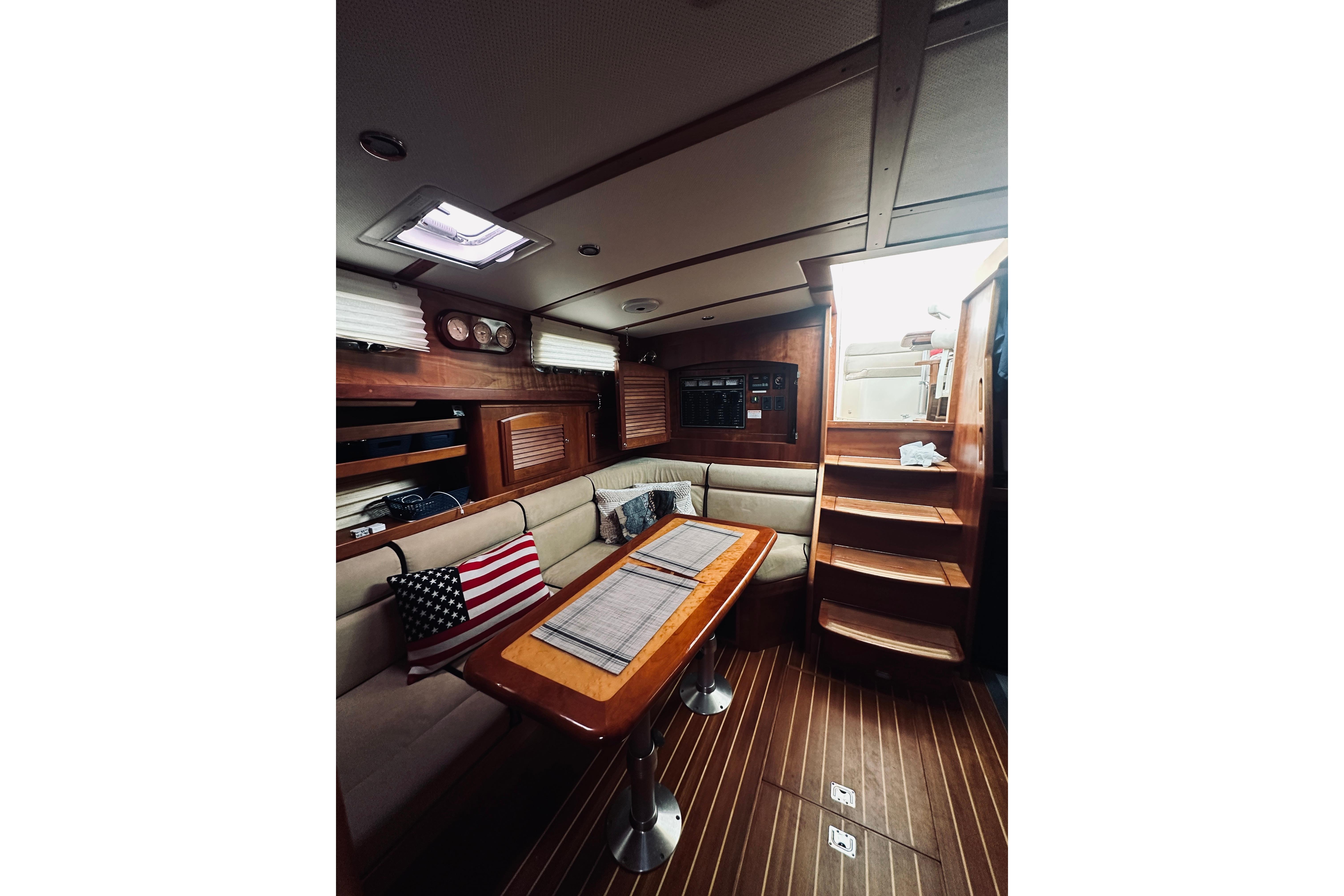 Interior of 2008 Sabre 38 Hard Top Express yacht with wooden finishes and seating area.