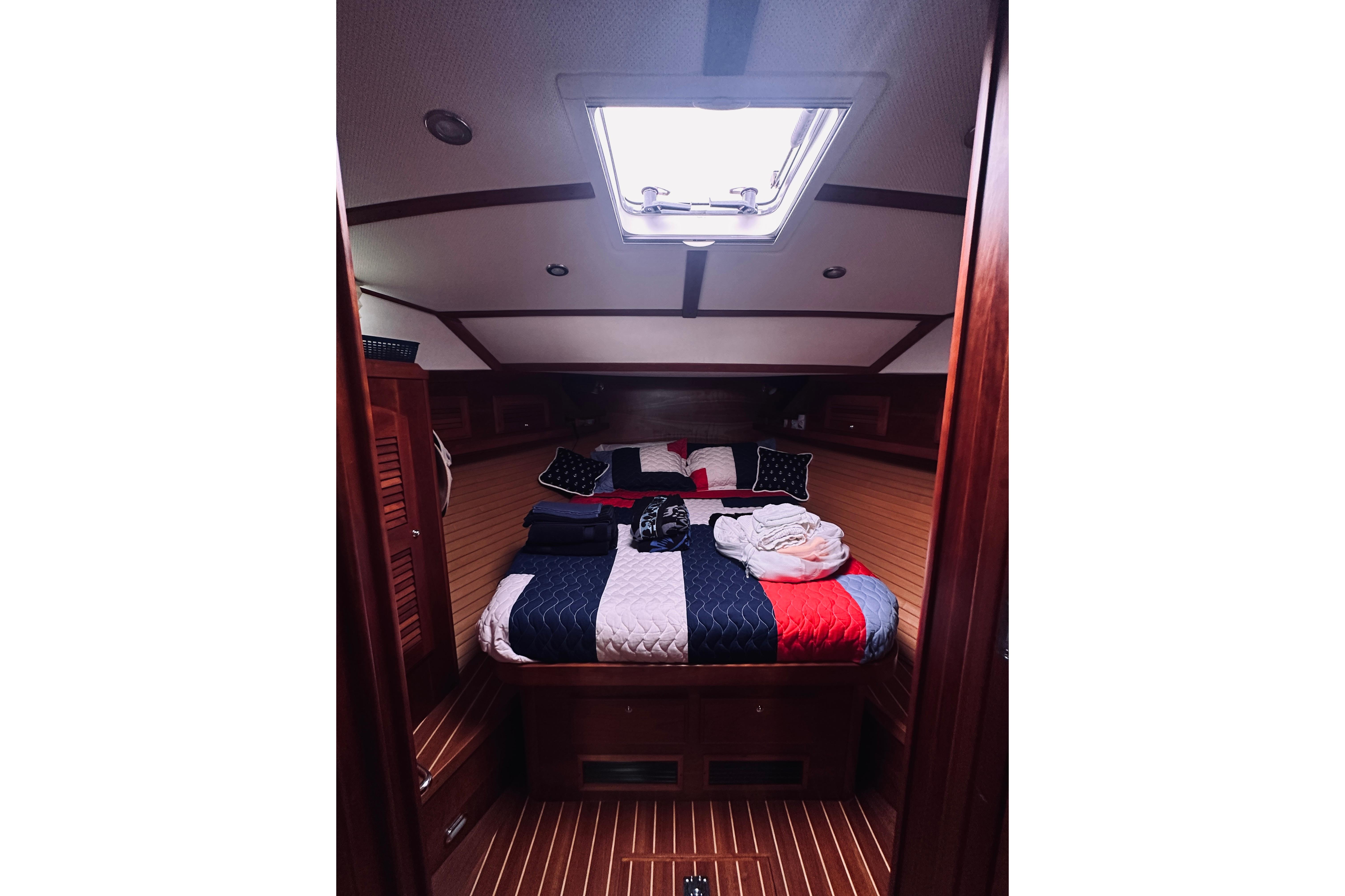 Luxurious cabin interior of 2008 Sabre 38 Hard Top Express yacht with cozy bedding.
