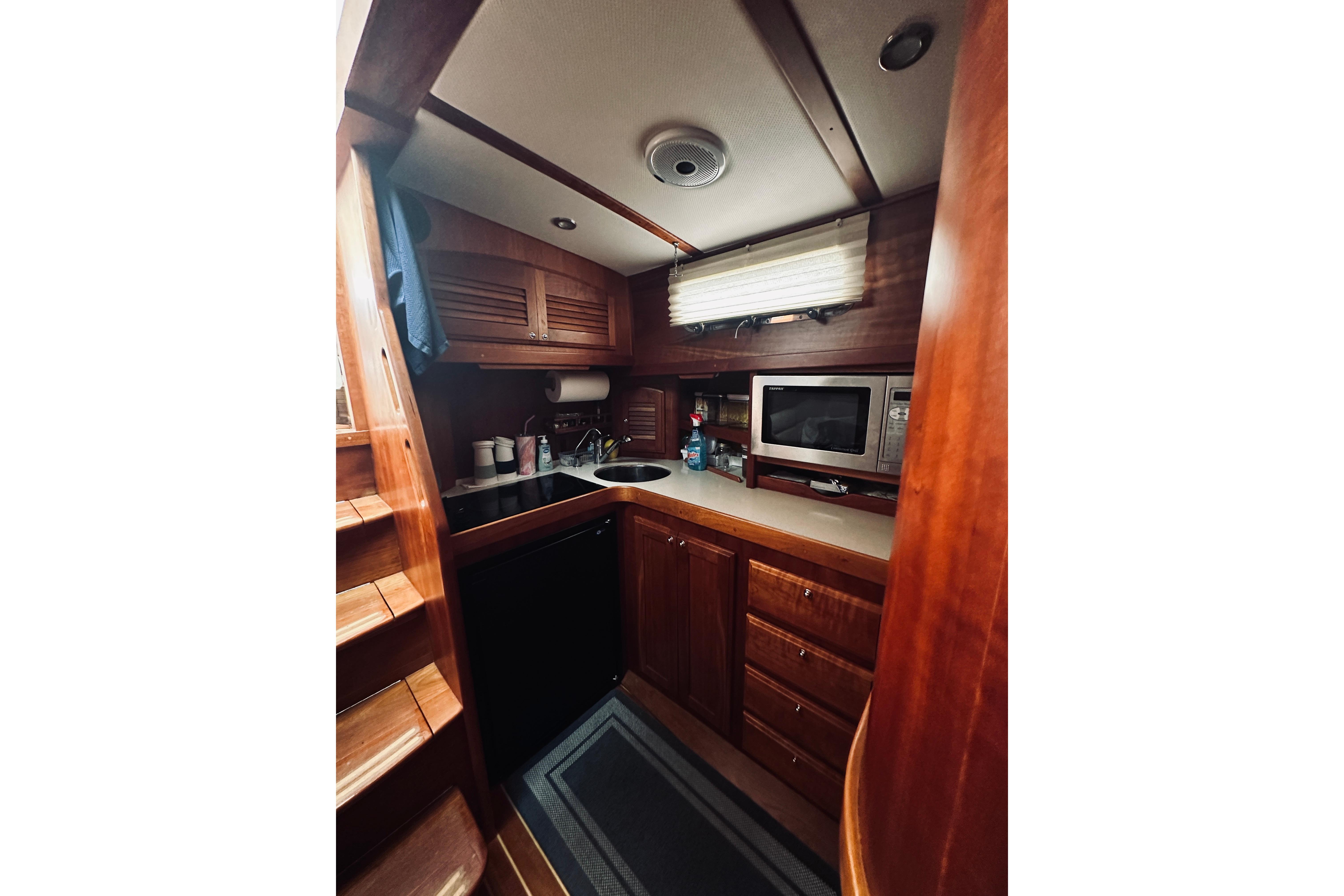 2008 Sabre 38 Hard Top Express yacht interior kitchen with wood cabinetry and modern appliances.