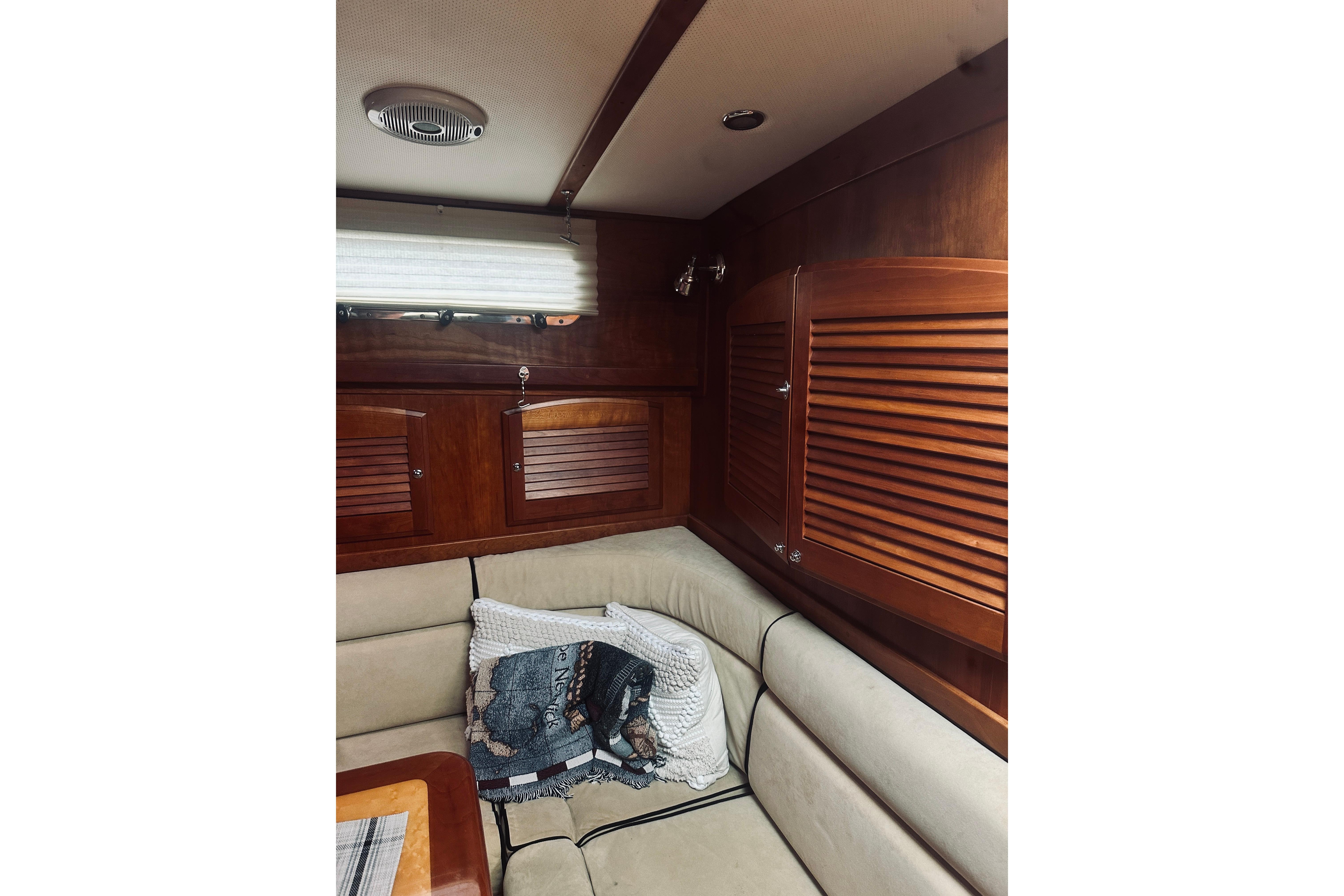 Interior of 2008 Sabre 38 Hard Top Express with wood paneling and beige seating.
