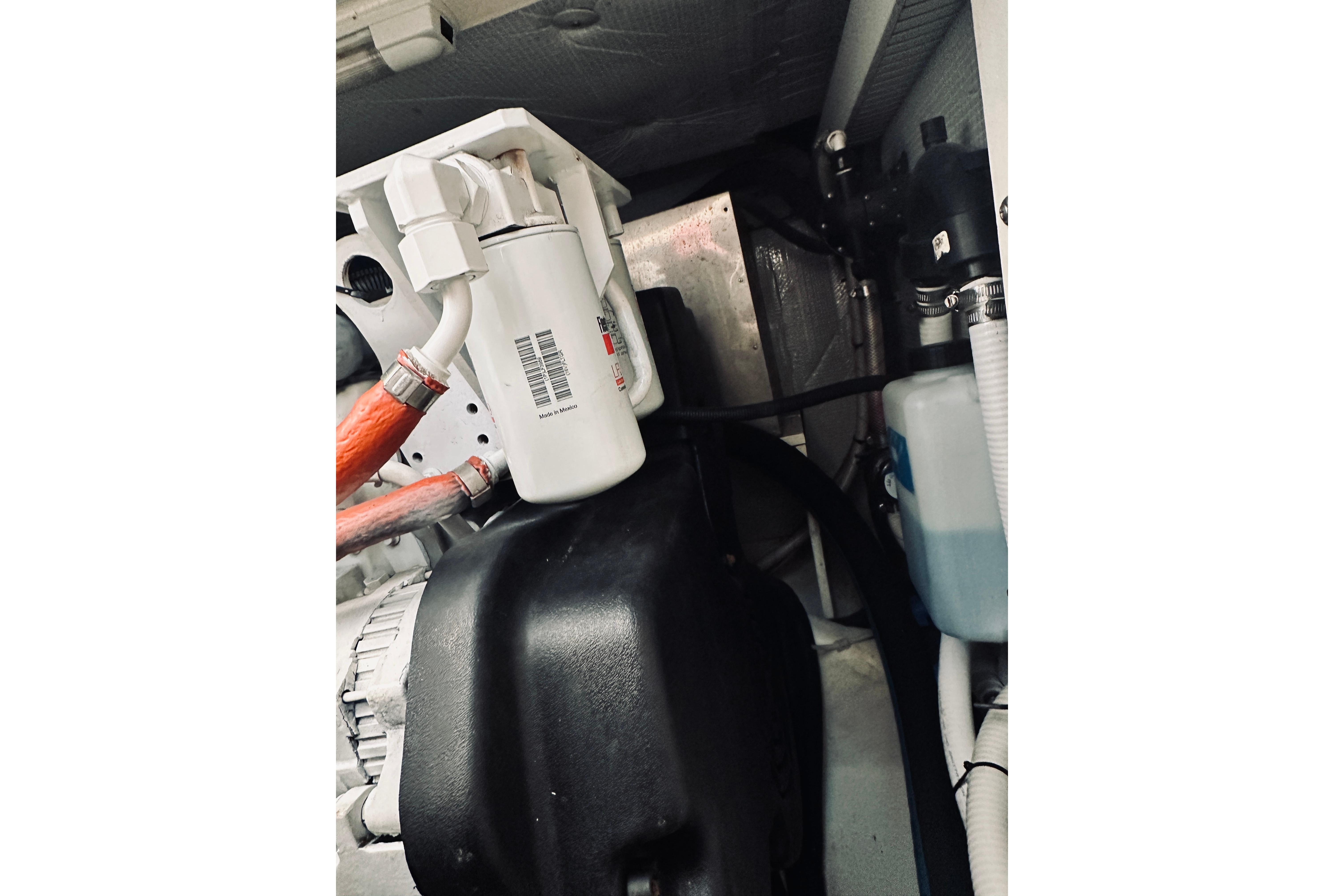 Engine compartment of a 2008 Sabre 38 Hard Top Express boat, showing filters and hoses.