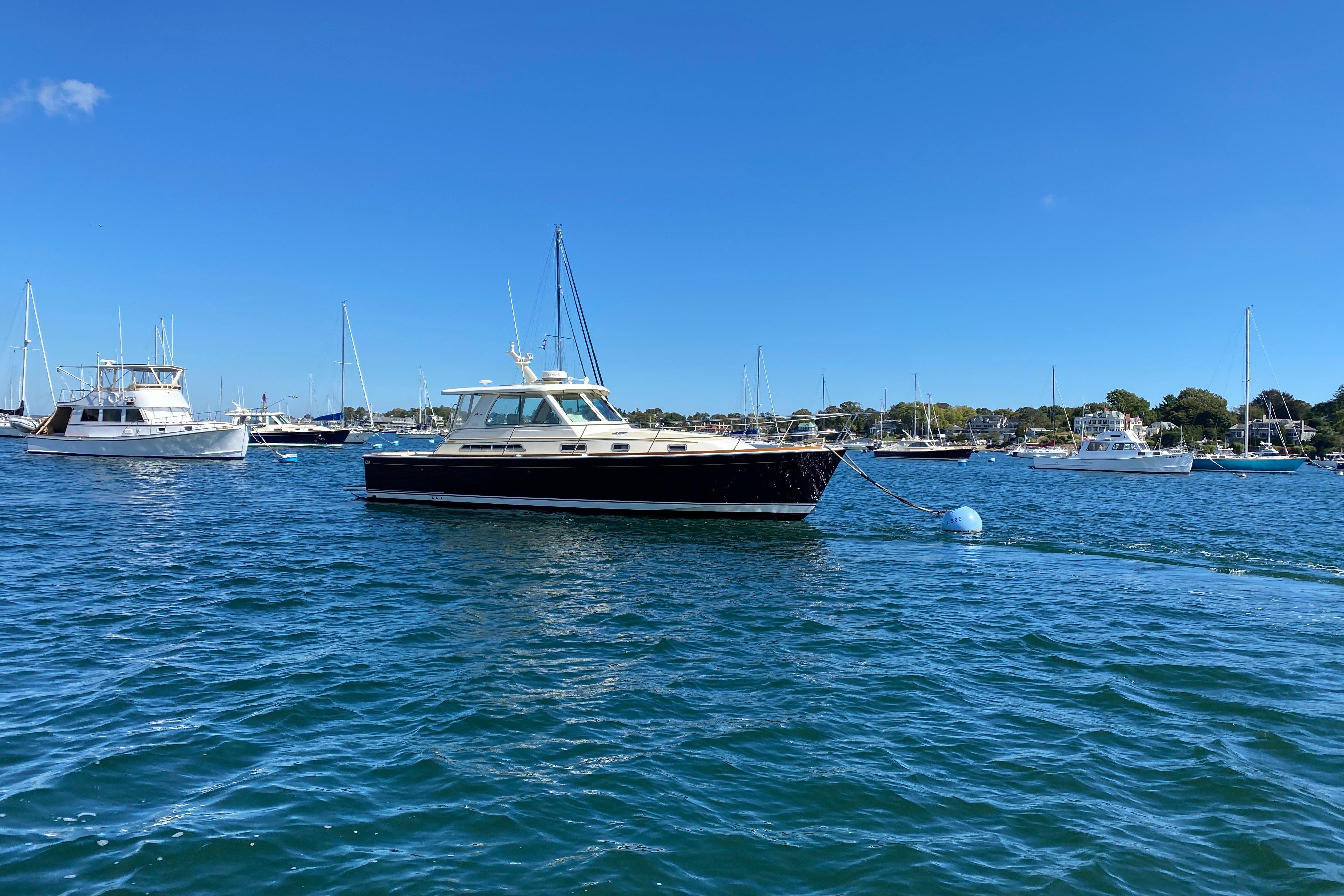 2008 Sabre 38 Hard Top Express yacht moored in a scenic harbor.
