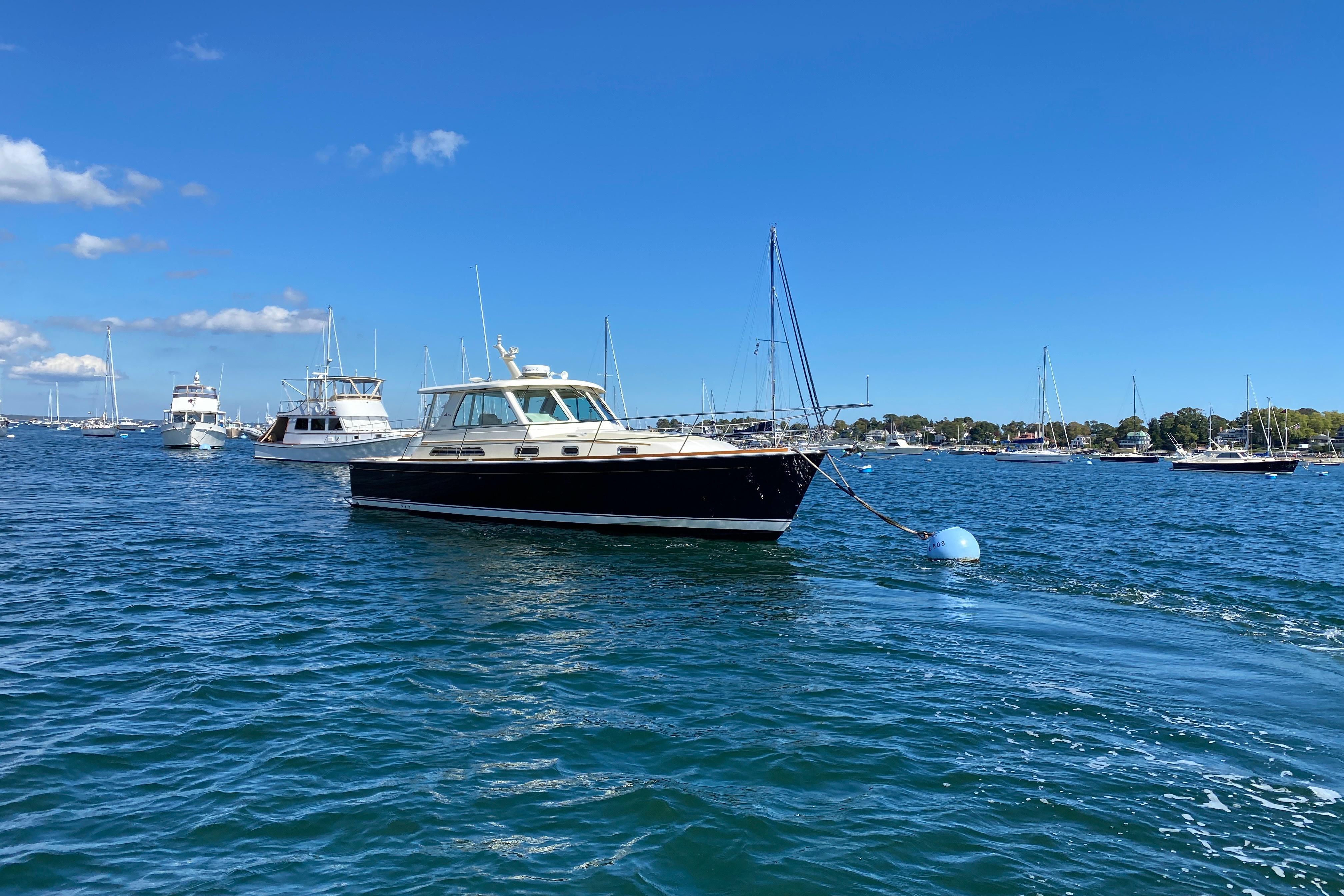2008 Sabre 38 Hard Top Express yacht moored in a scenic harbor.