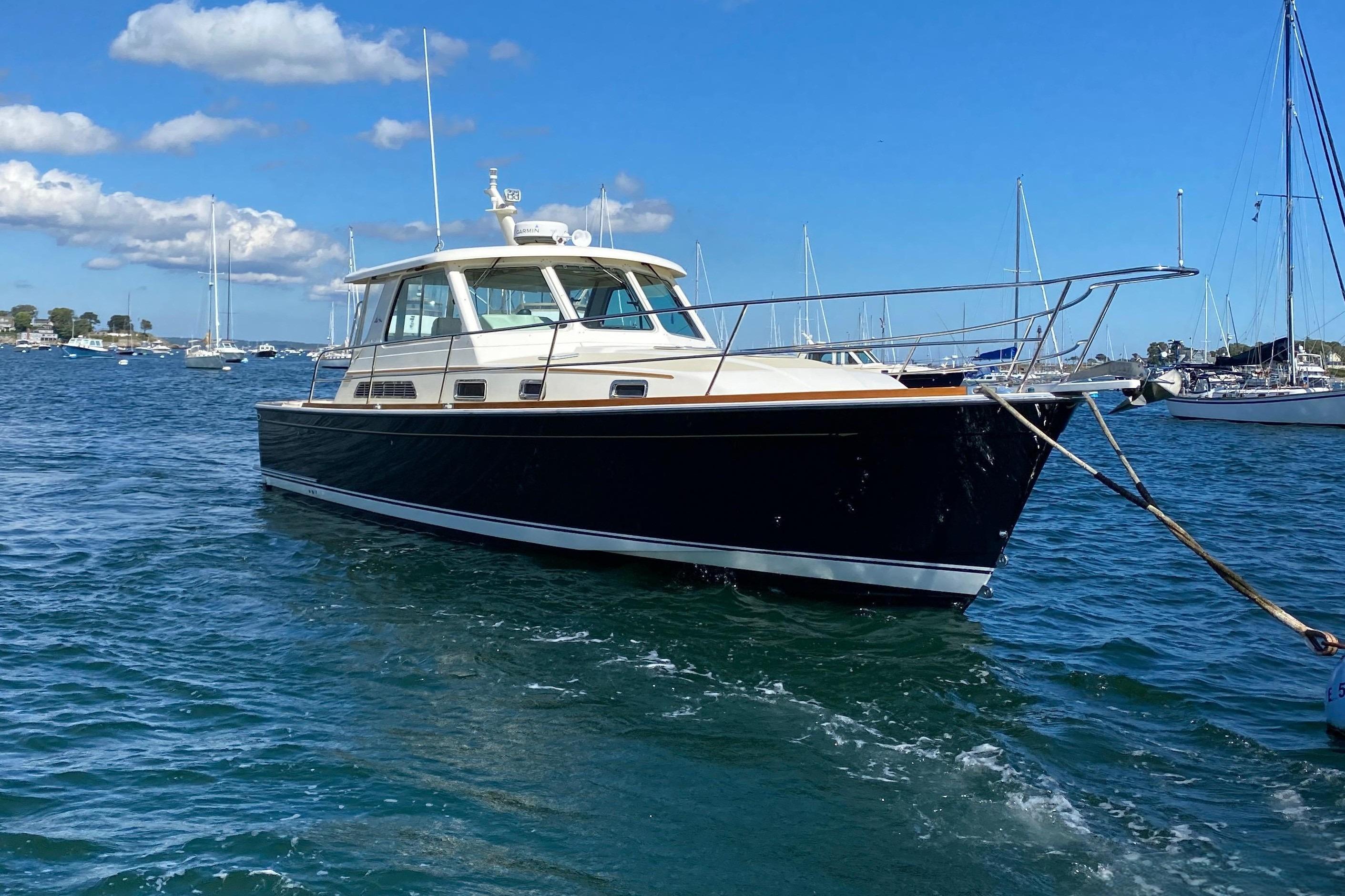 2008 Sabre 38 Hard Top Express yacht on calm blue water under clear sky.