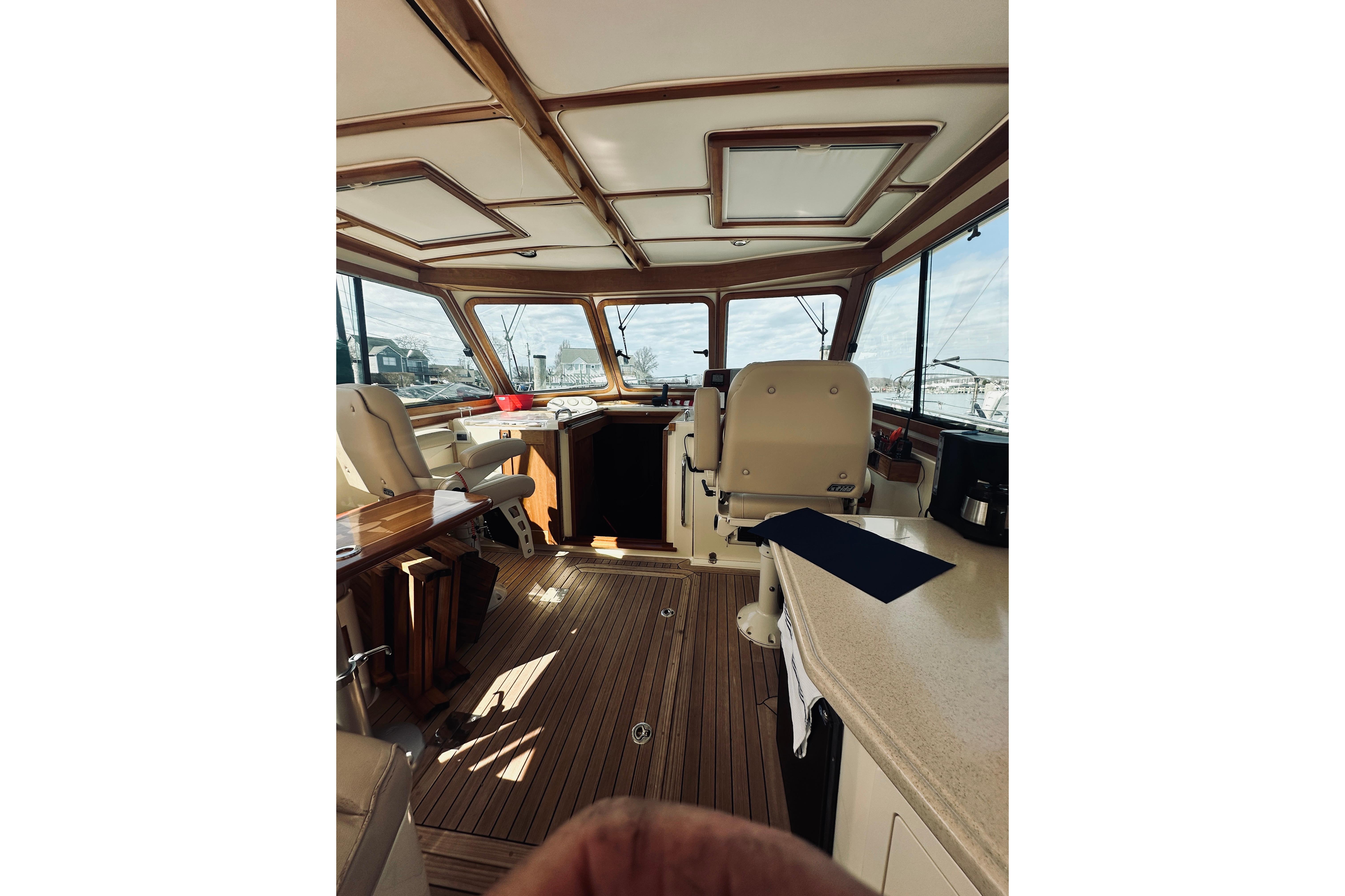 Interior of 2008 Sabre 38 Hard Top Express yacht with wooden flooring and helm station.