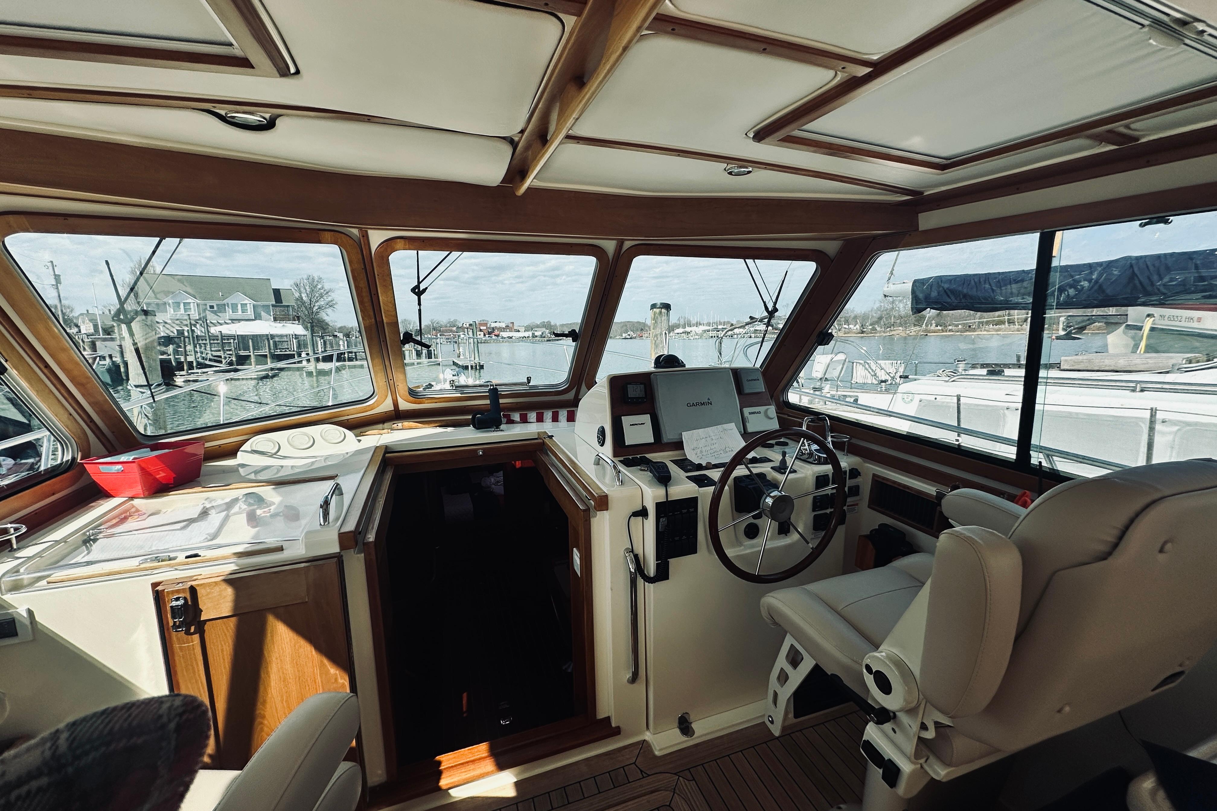 2008 Sabre 38 Hard Top Express boat interior with helm, marina view, and comfortable seating.