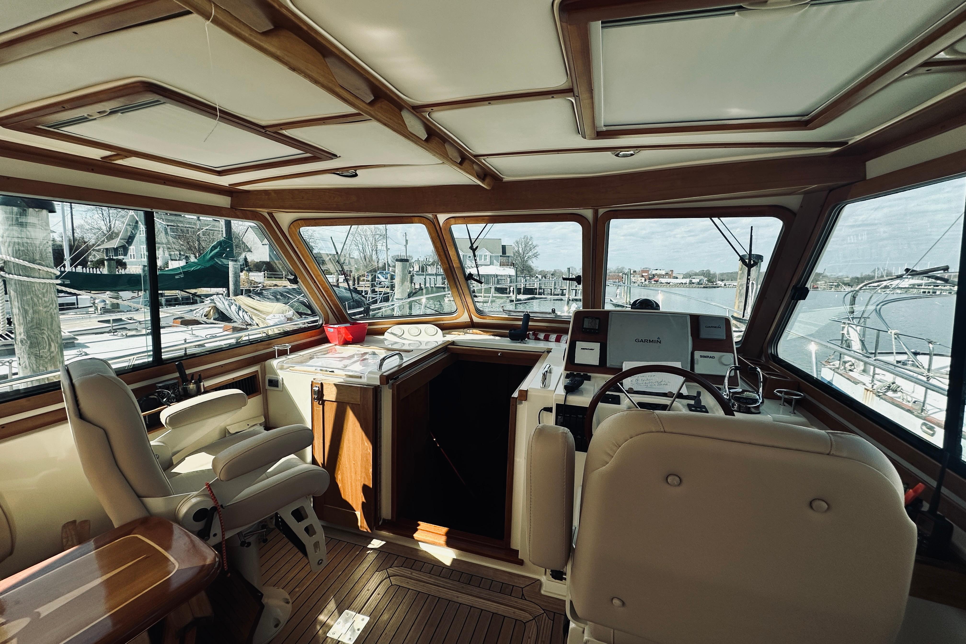 2008 Sabre 38 Hard Top Express yacht interior with helm, seating, and marina view.