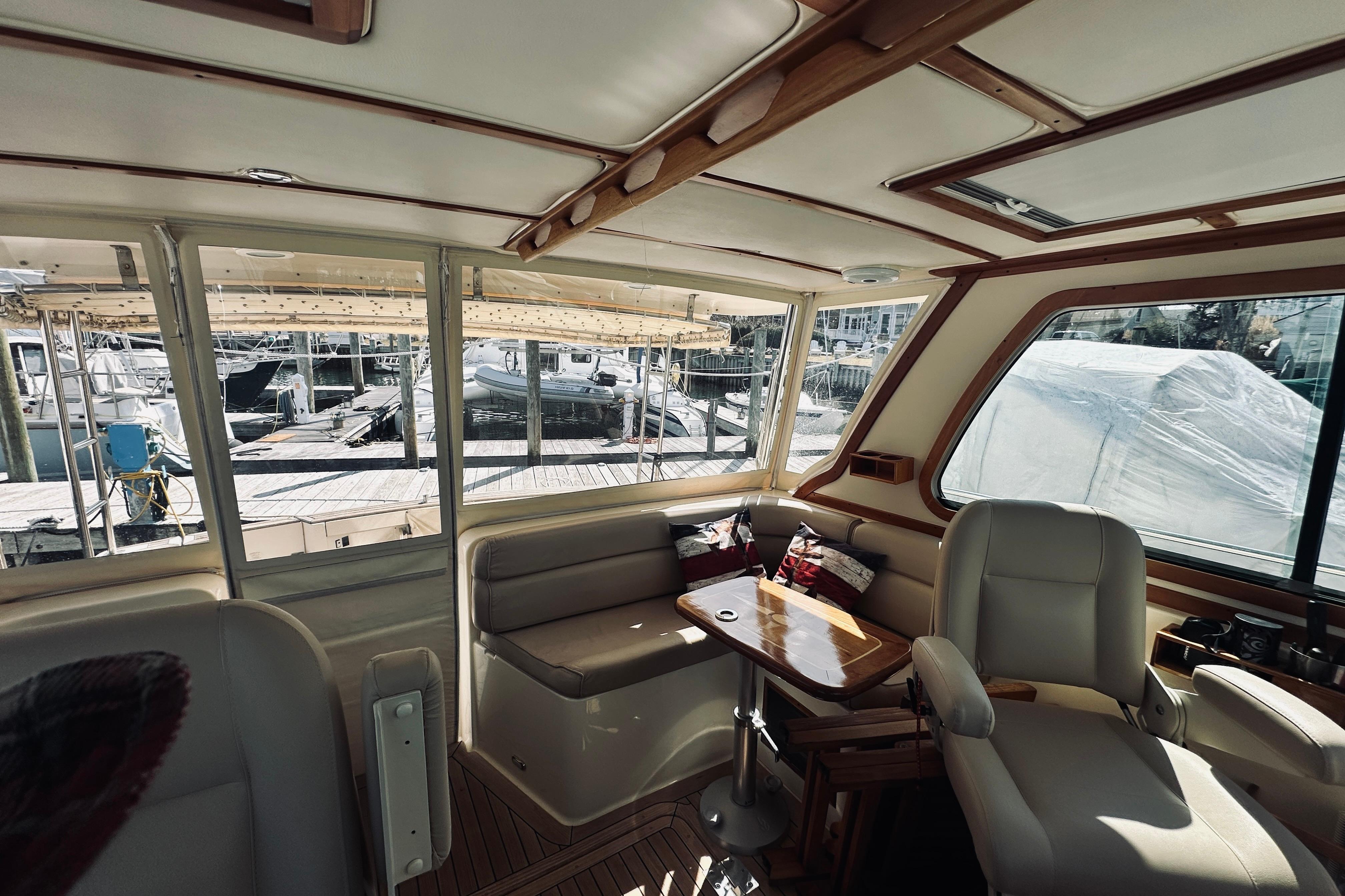 Interior of 2008 Sabre 38 Hard Top Express yacht, featuring seating and wooden accents.