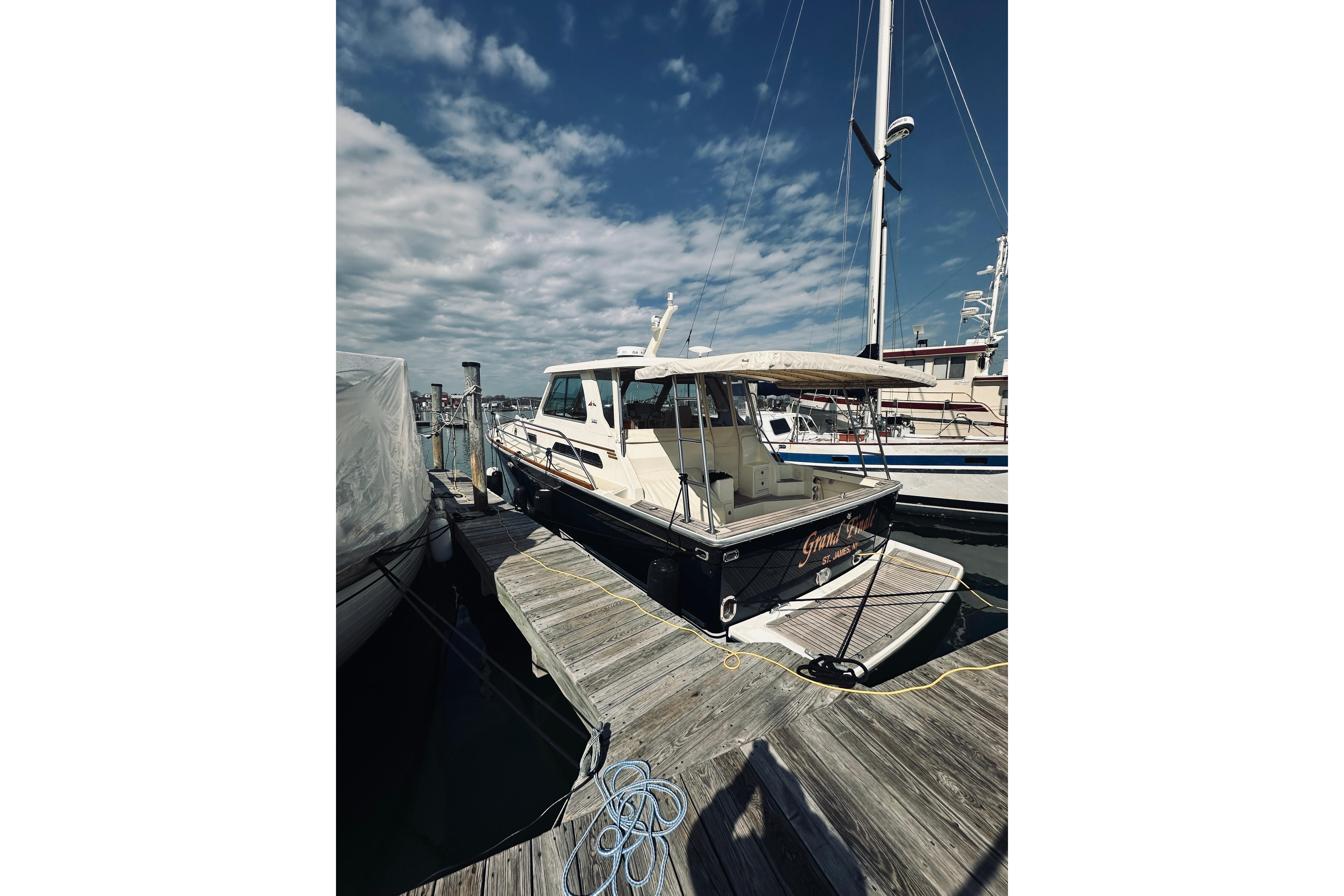 2008 Sabre 38 Hard Top Express docked at marina under blue sky.
