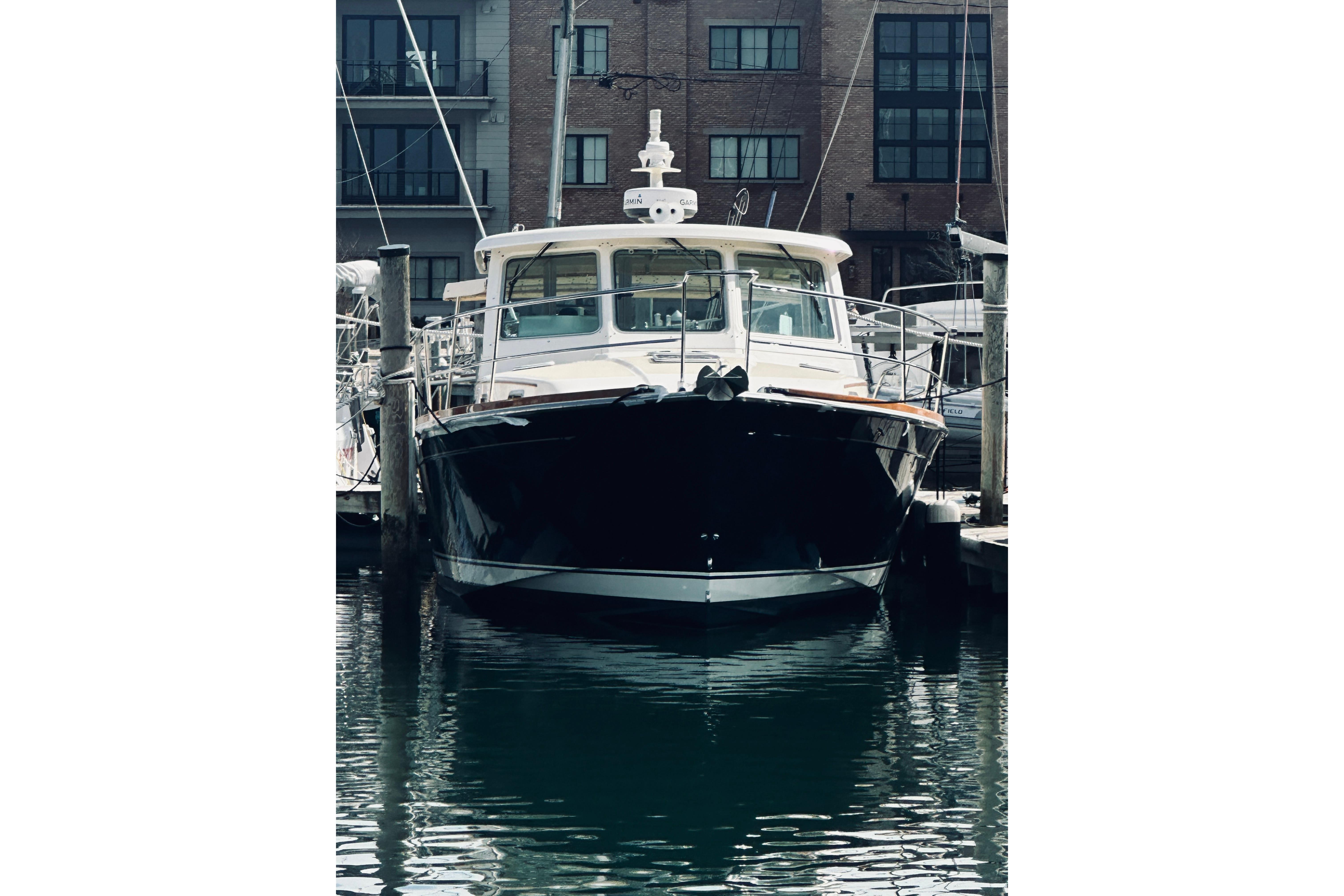 2008 Sabre 38 Hard Top Express yacht docked in marina, front view.