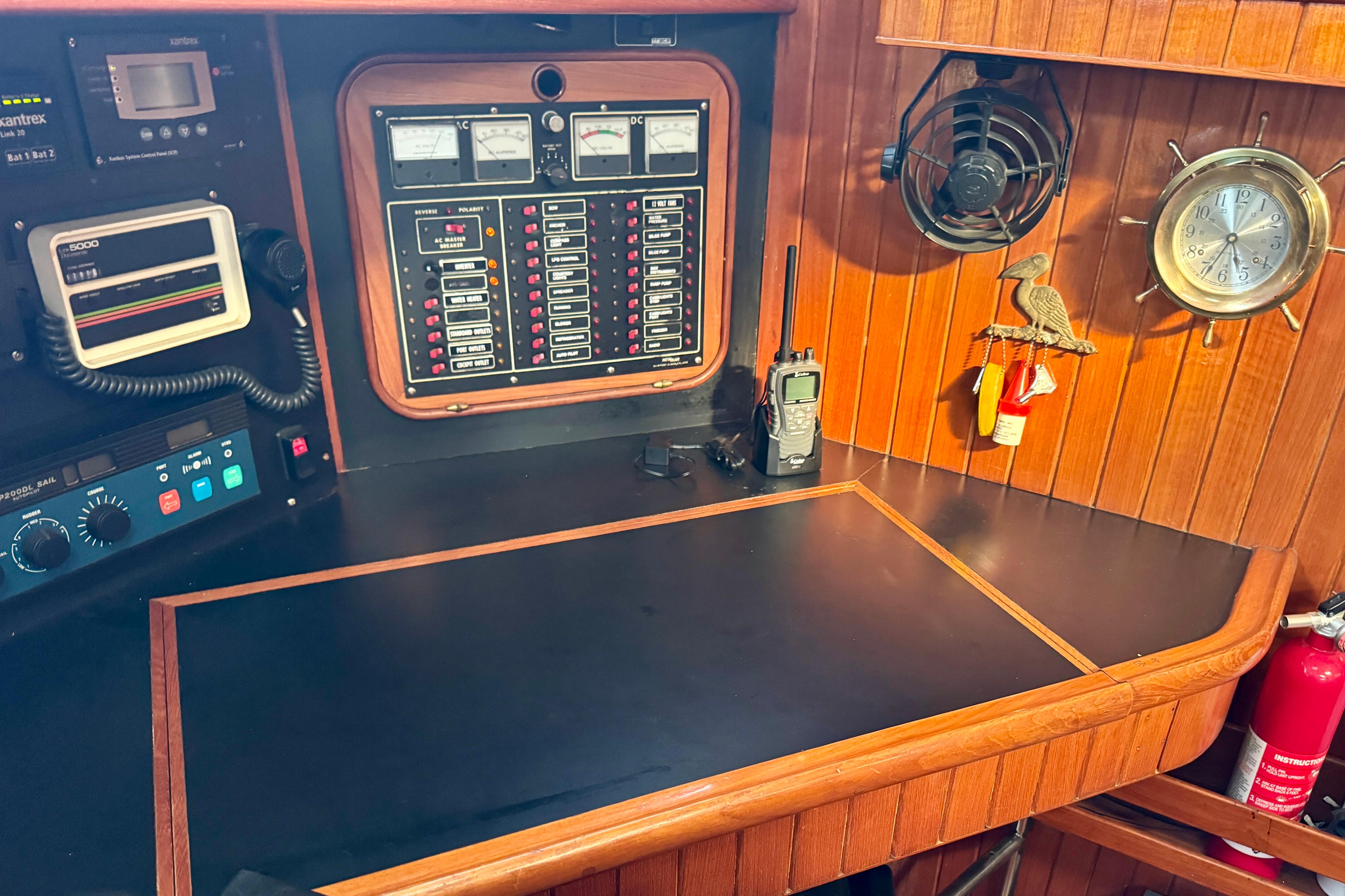 Navigation station of 1988 Hans Christian Christina sailboat with control panels and equipment.