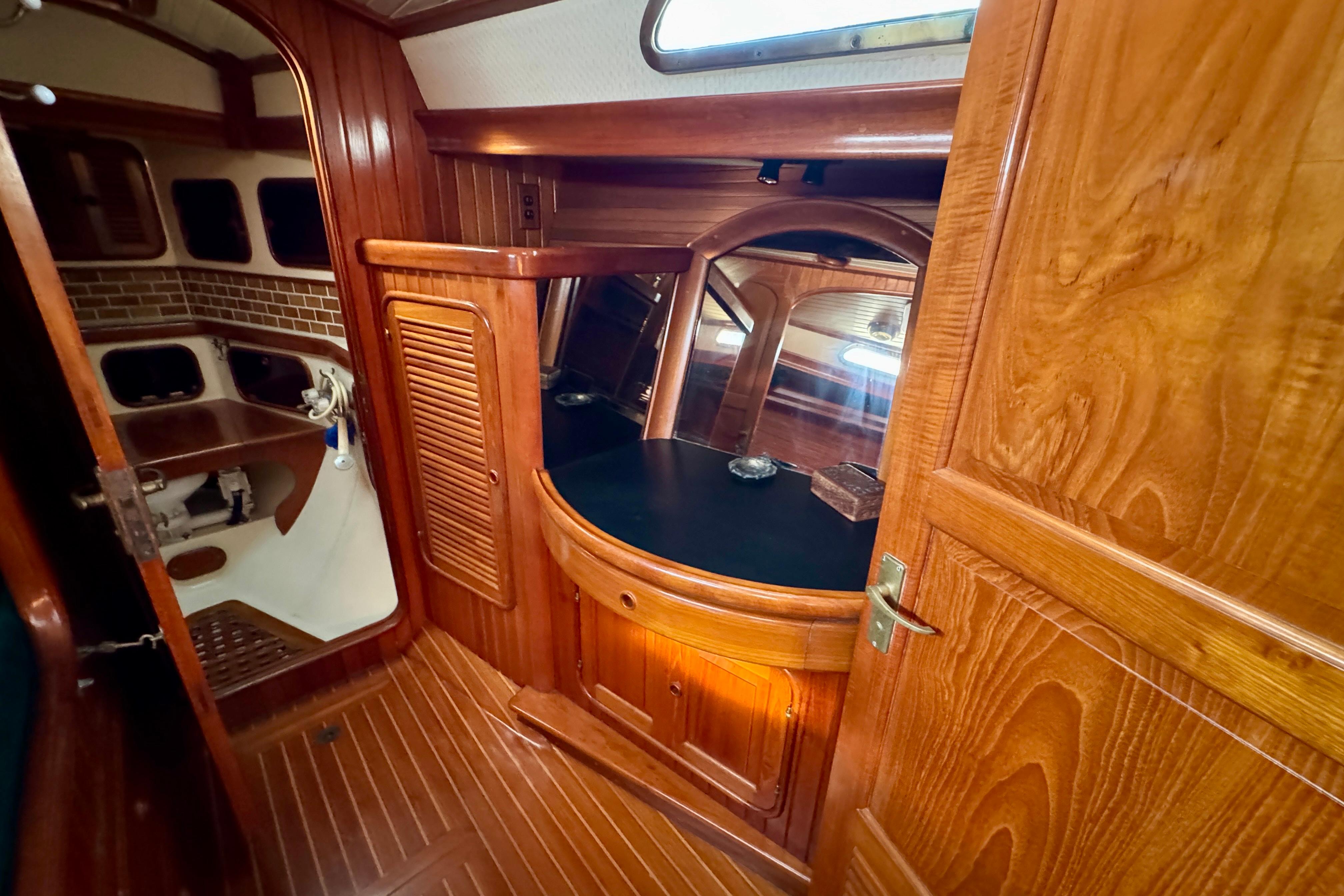 1988 Hans Christian Christina yacht interior with wooden cabinetry and nautical design.