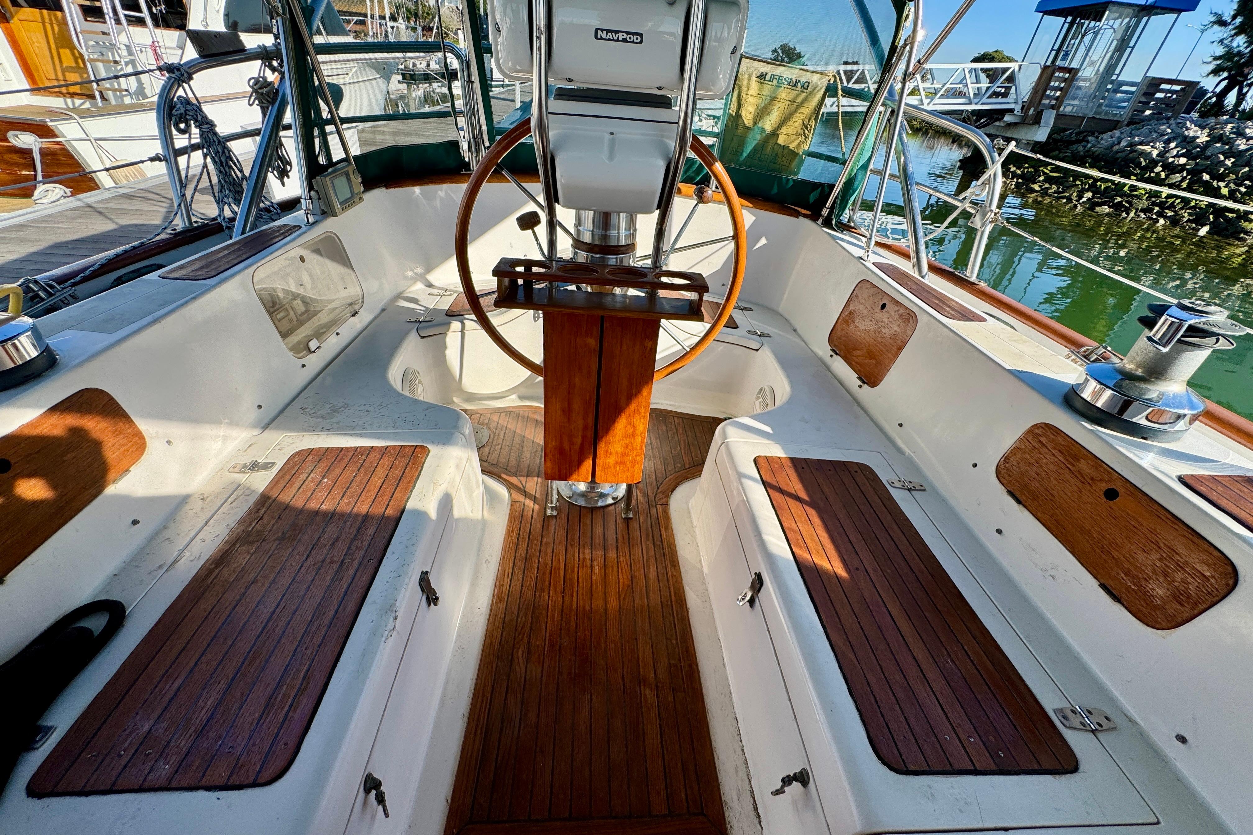 Cockpit of 1988 Hans Christian Christina sailboat with wooden accents and steering wheel.