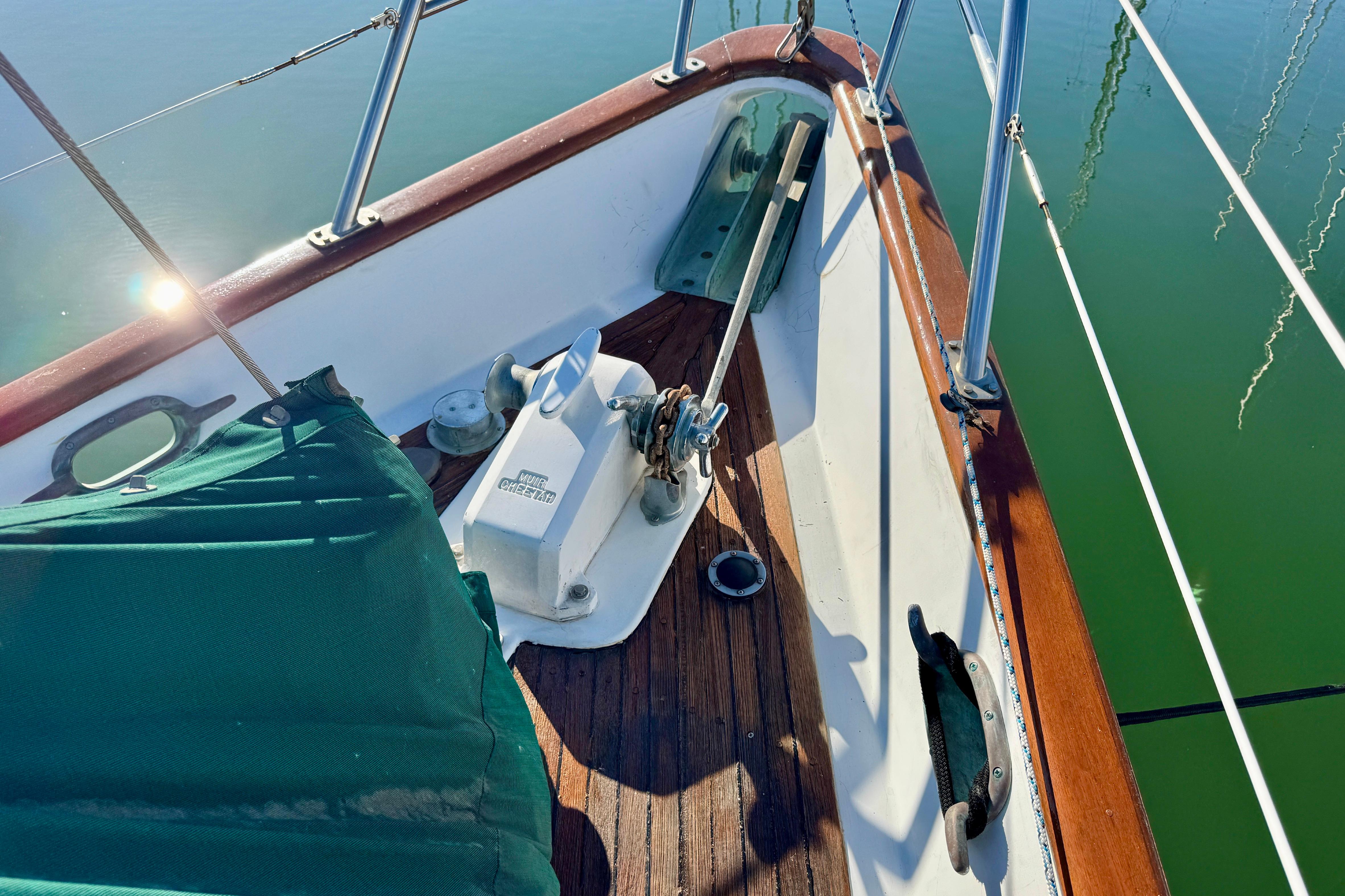 Deck of 1988 Hans Christian Christina sailboat with anchor and green cover.