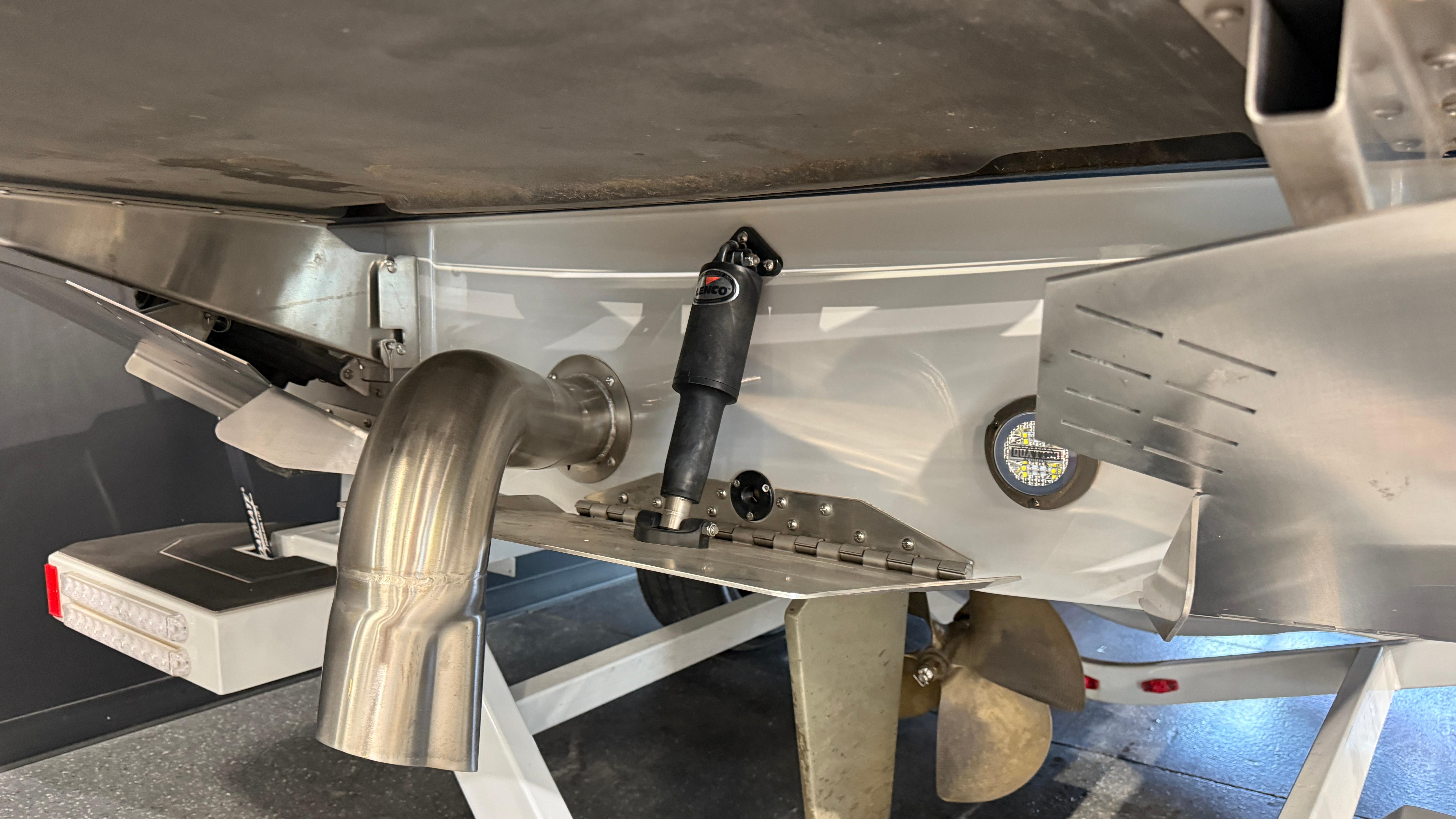 2022 Tigé 23ZX boat underside showing exhaust, propeller, and trim tab details.