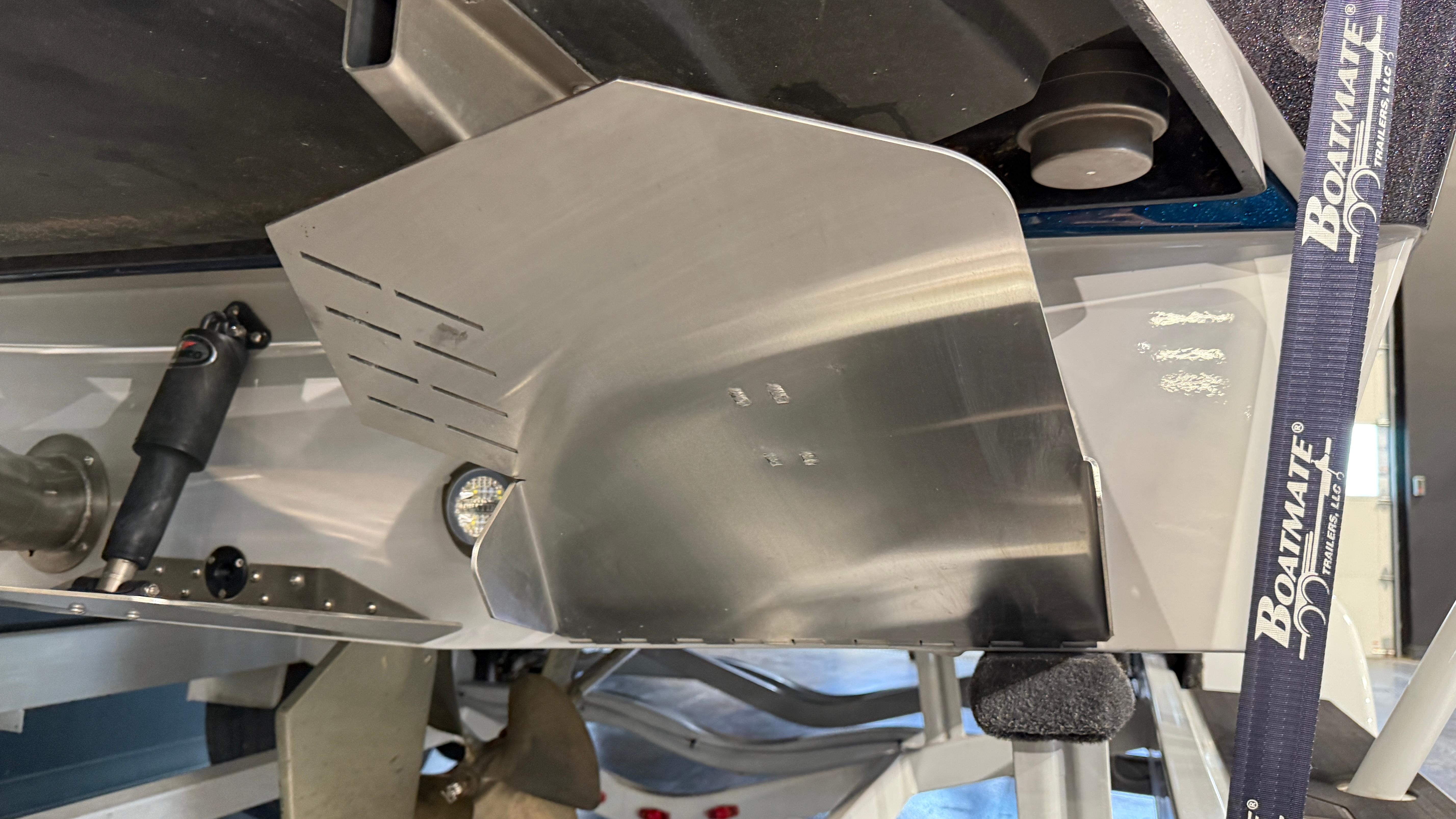 2022 Tigé 23ZX boat underside with metal components and Boatmate trailer strap.
