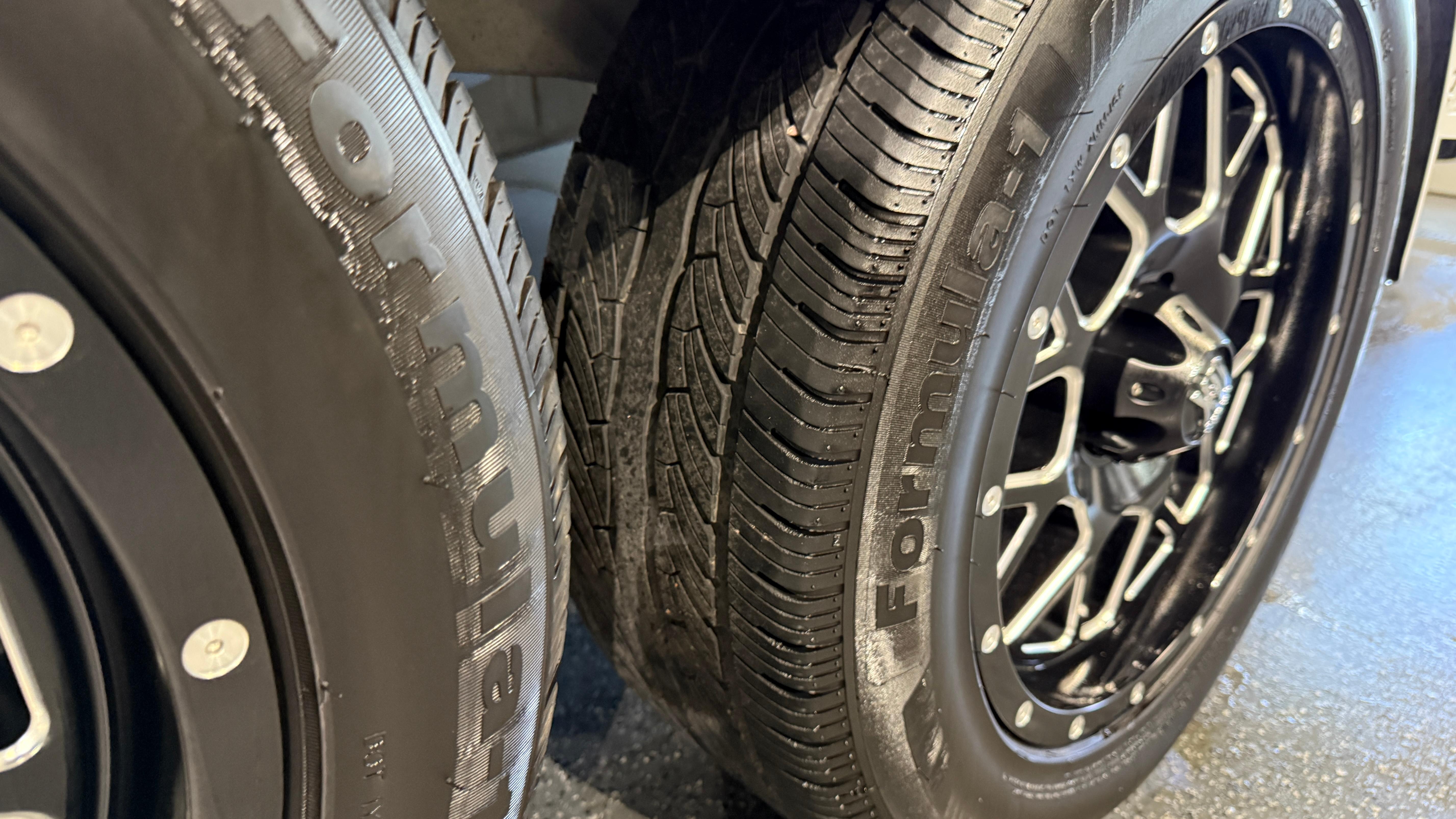 Close-up of 2022 Tigé 23ZX trailer wheels with black alloy rims.
